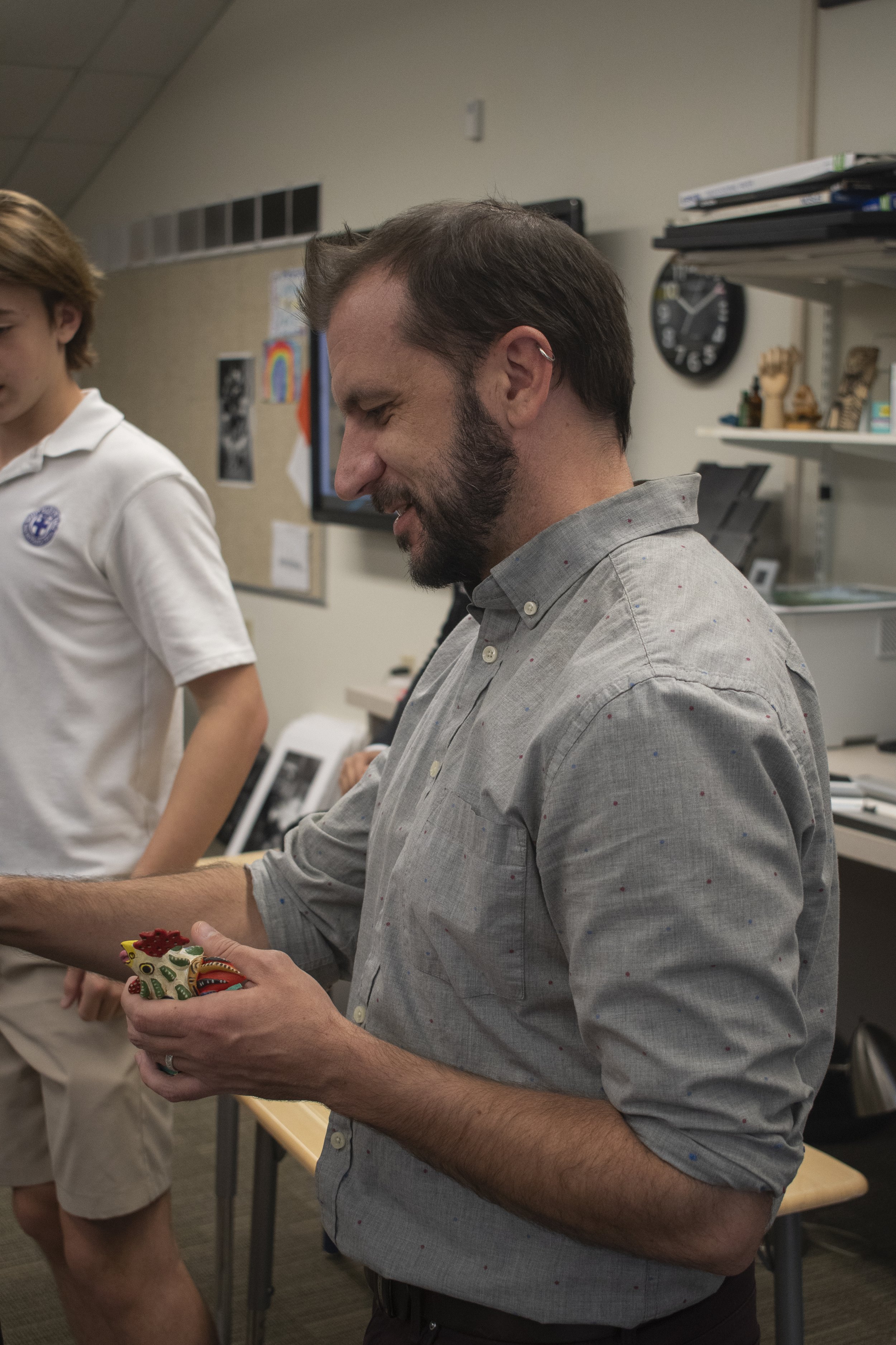 Mr. Petersen encourages his students to show their fun and creative sides. He does this by making them use obscure objects as the subject of his photos, here he holds a student's chicken figurine that they took from their mom's kitchen.