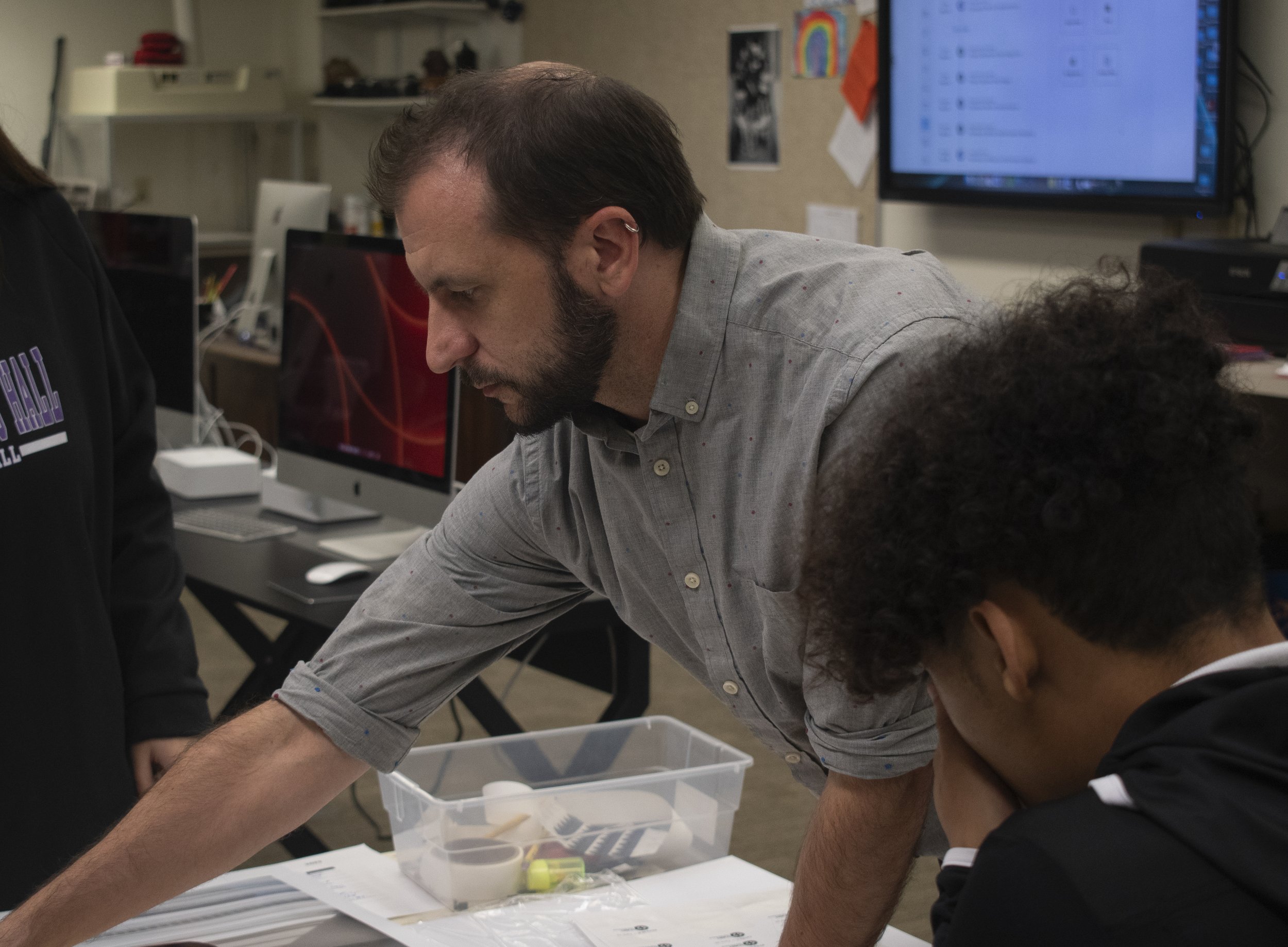 Kyle Petersen is the photography teacher at Saint Mary's Hall. He likes to show off his students' work and teaches them how to mat their photos.