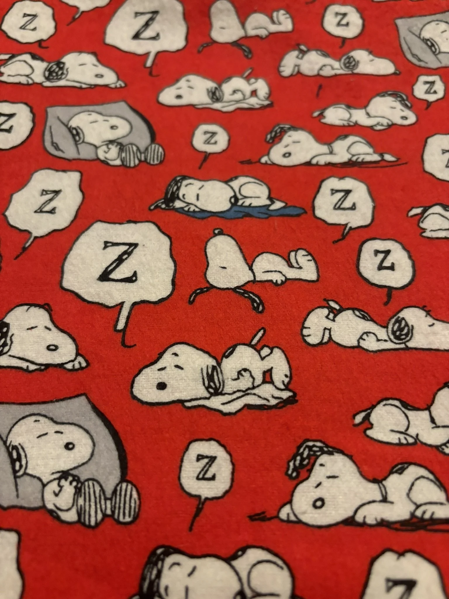 Snoopy sleeping on Red Cotton
