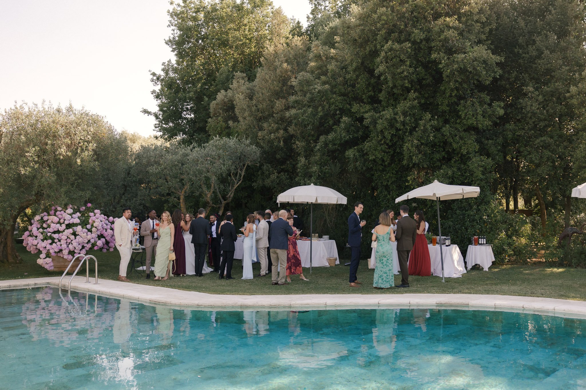 Wedding guests enjoying cocktail hour by the pool.jpg