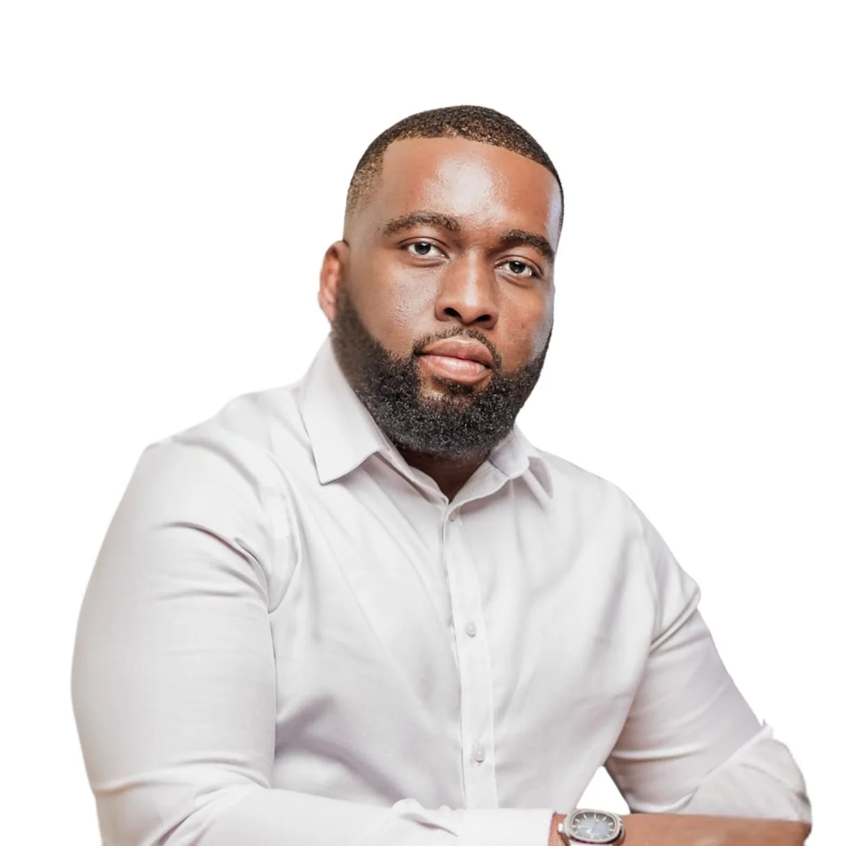 Portrait of a man with a beard wearing a white dress shirt against a white background.