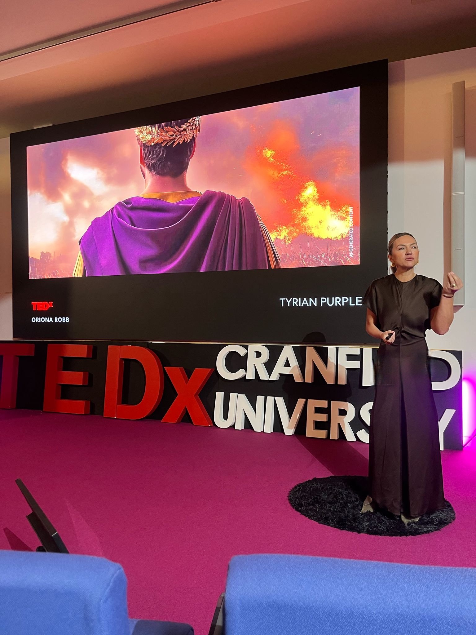 Oriona Robb speaking on stage at TEDx about style, presence and confidence