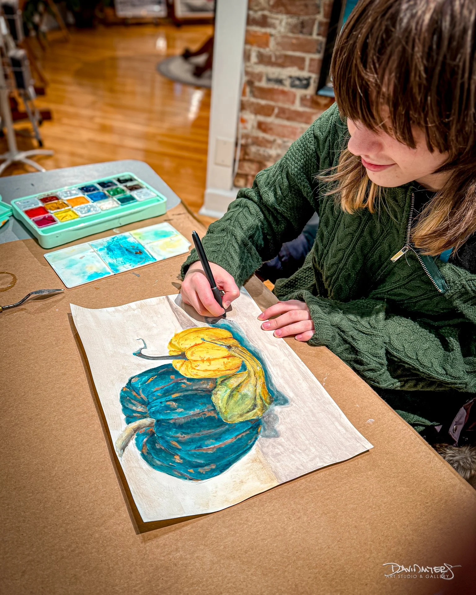 It&rsquo;s OK to Be Moldy
Liliana signs her watercolor, It&rsquo;s OK to Be Moldy, a study of two pumpkins and a gourd that aged considerably during the process. Keenly observant and deeply aware, she brings a heightened sensitivity to detail and an 