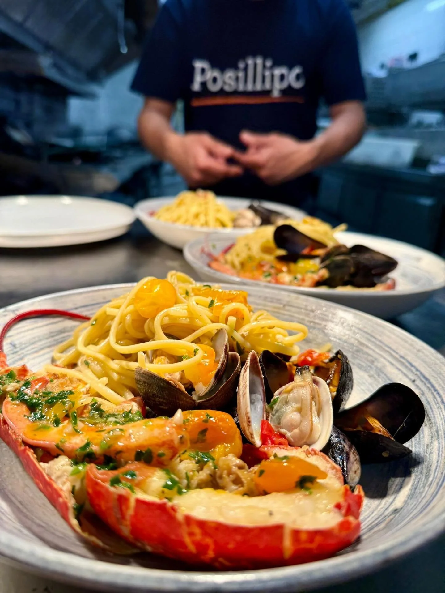 Fresh from the sea, straight to your plate. Our Linguine with Lobster, Clams &amp; Mussels is summer on a fork 🦞

And speaking of summer, our kitchen crew is keeping cool in style with the new Posillipo chef tops, perfect for the heat! Big thanks to