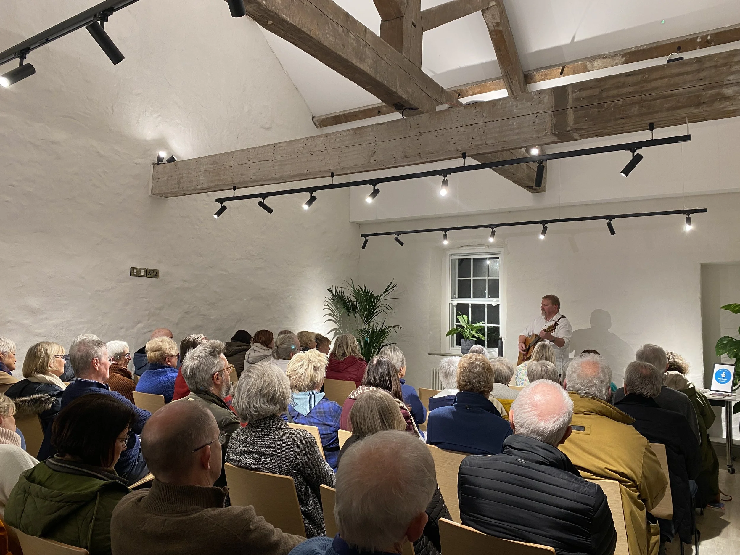 An audience watching colin urwin singing 