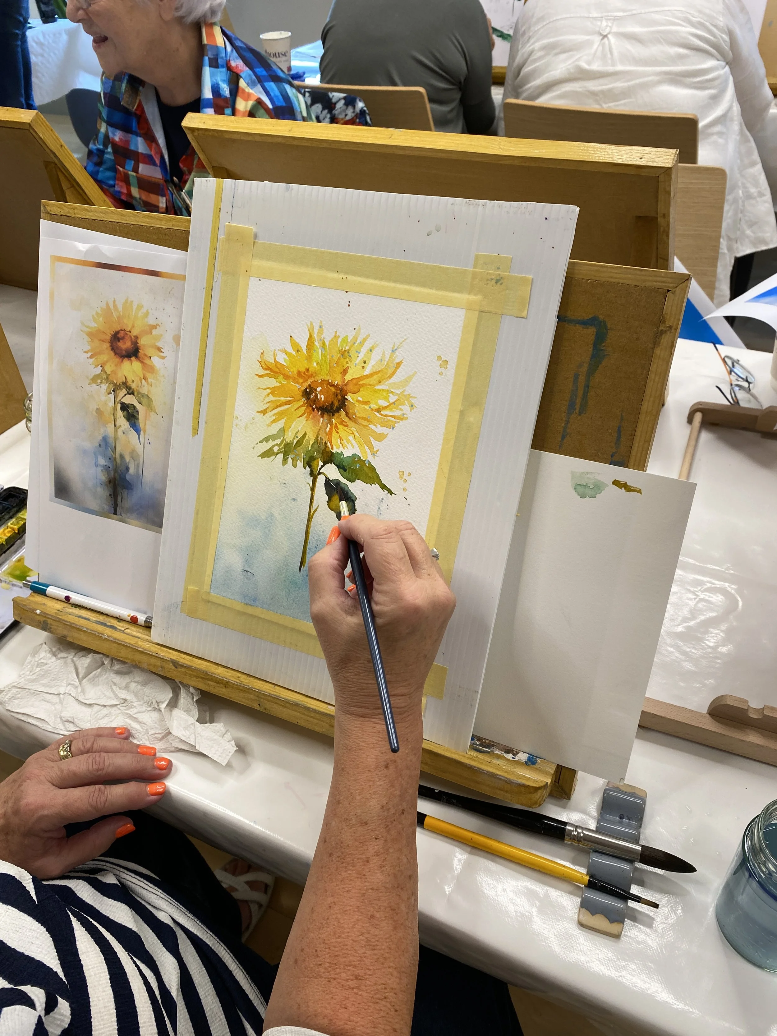 A woman painting at an easel