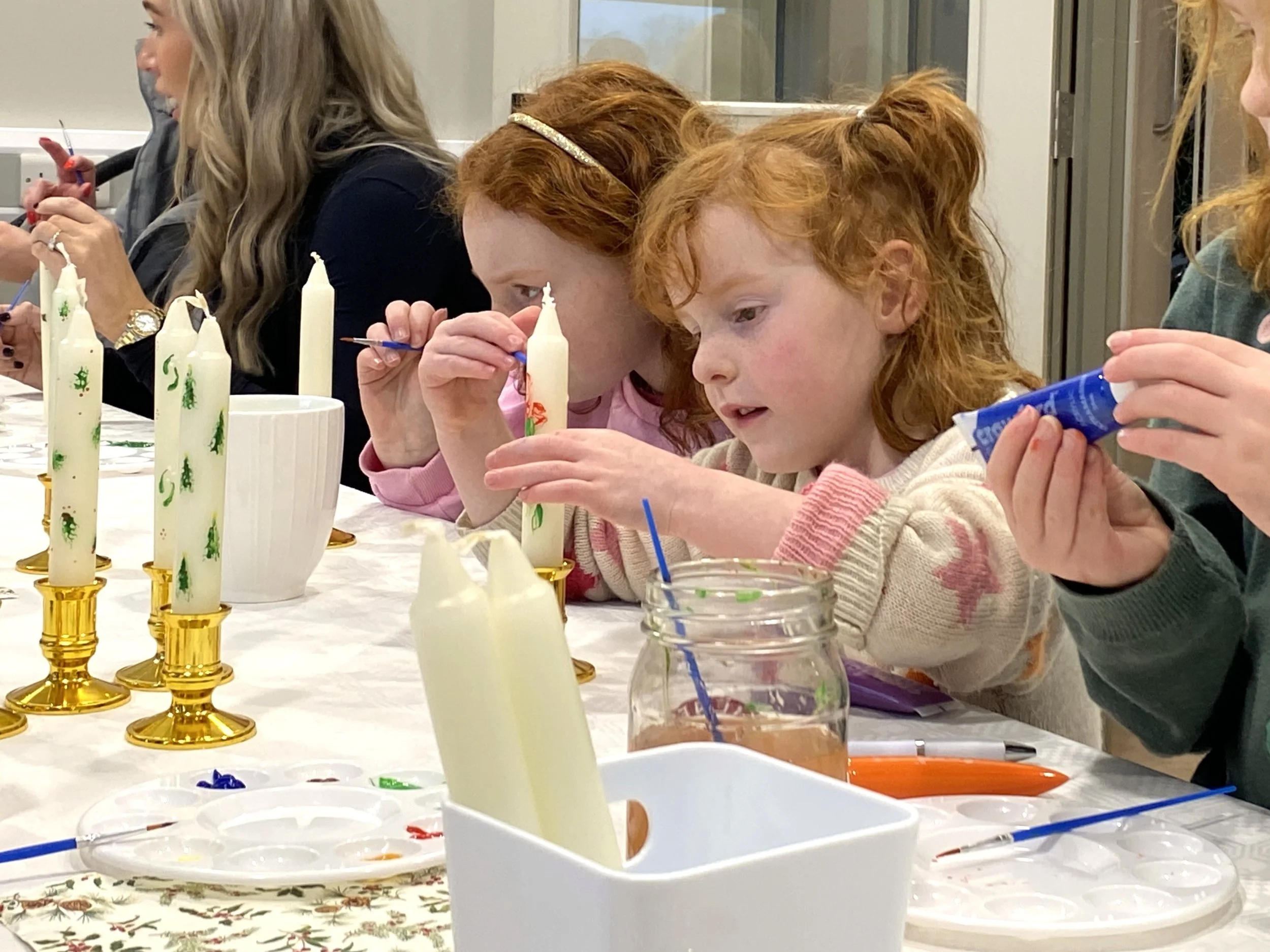 Two children with red hair crafting