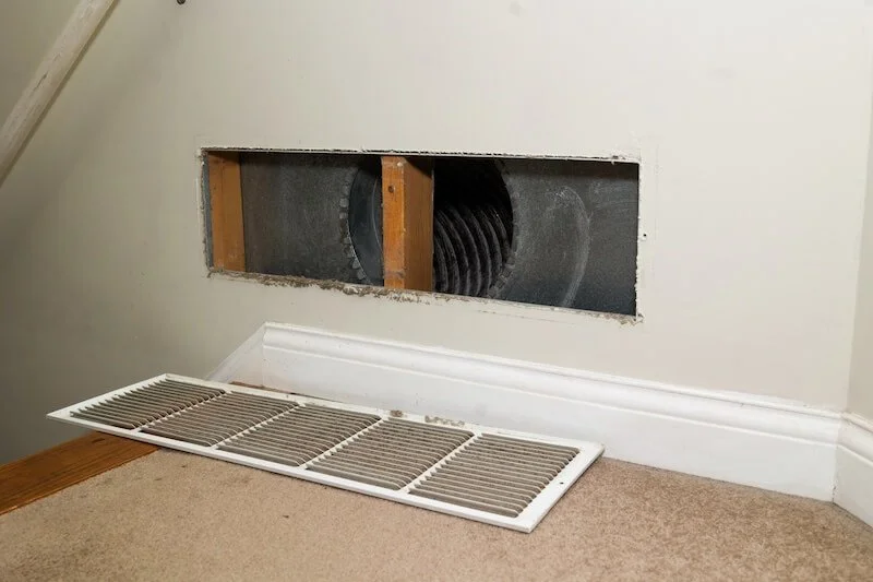 open vent of air duct being cleaned