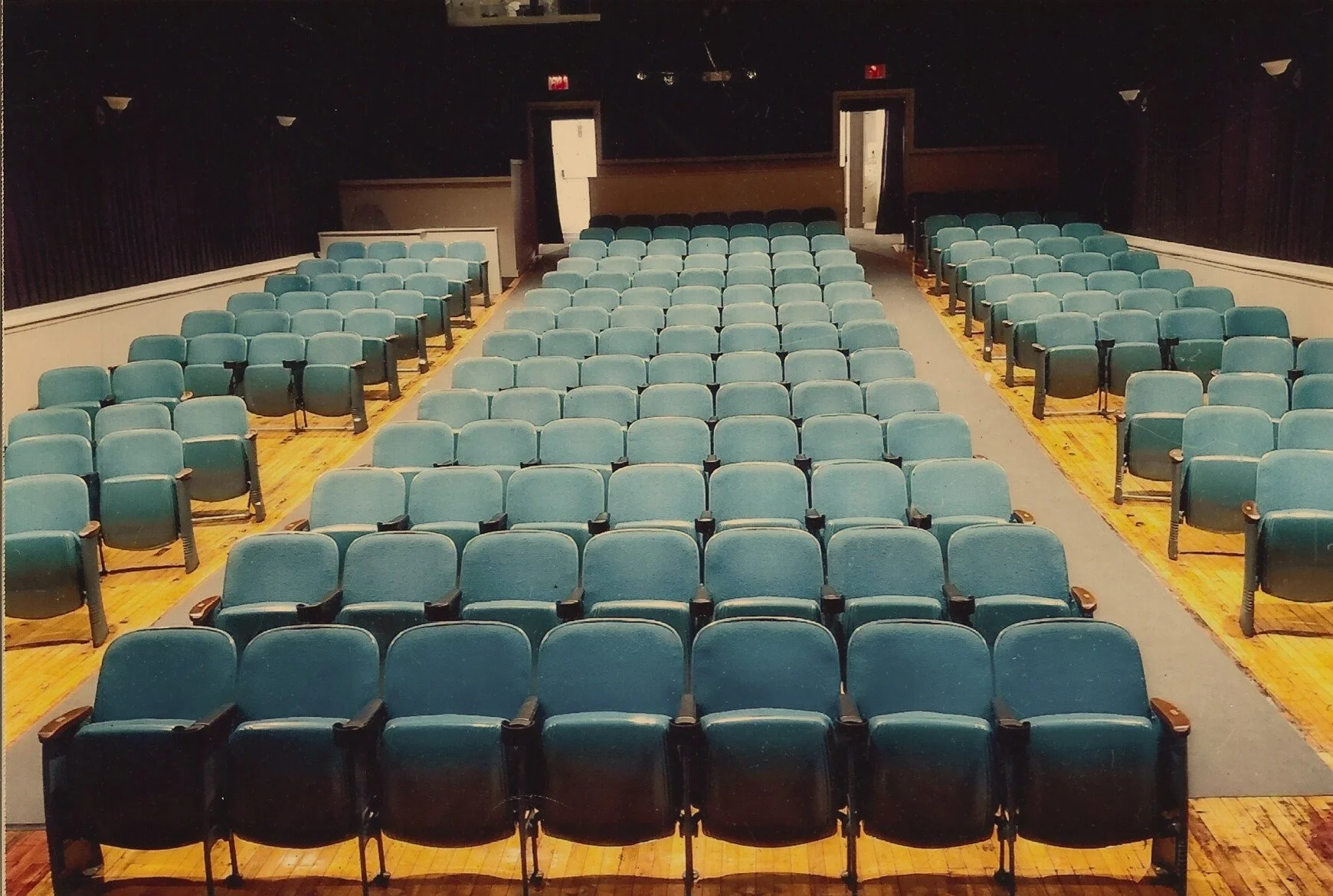 Picture of original blue seating in auditorium, before the "Take a seat" campaign.