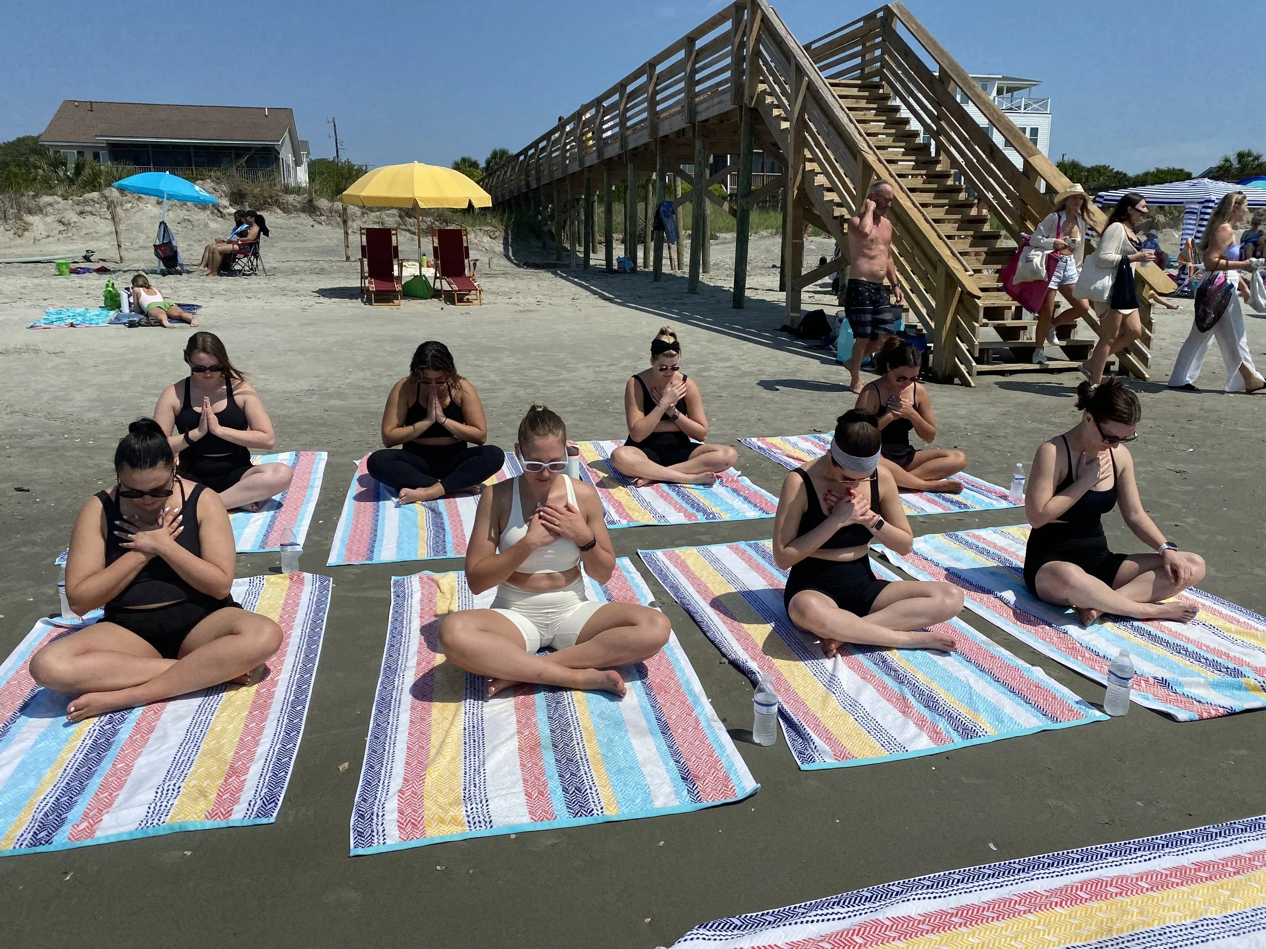 Private beach yoga class on Folly Beach for a Charleston Bachelorette Party. 