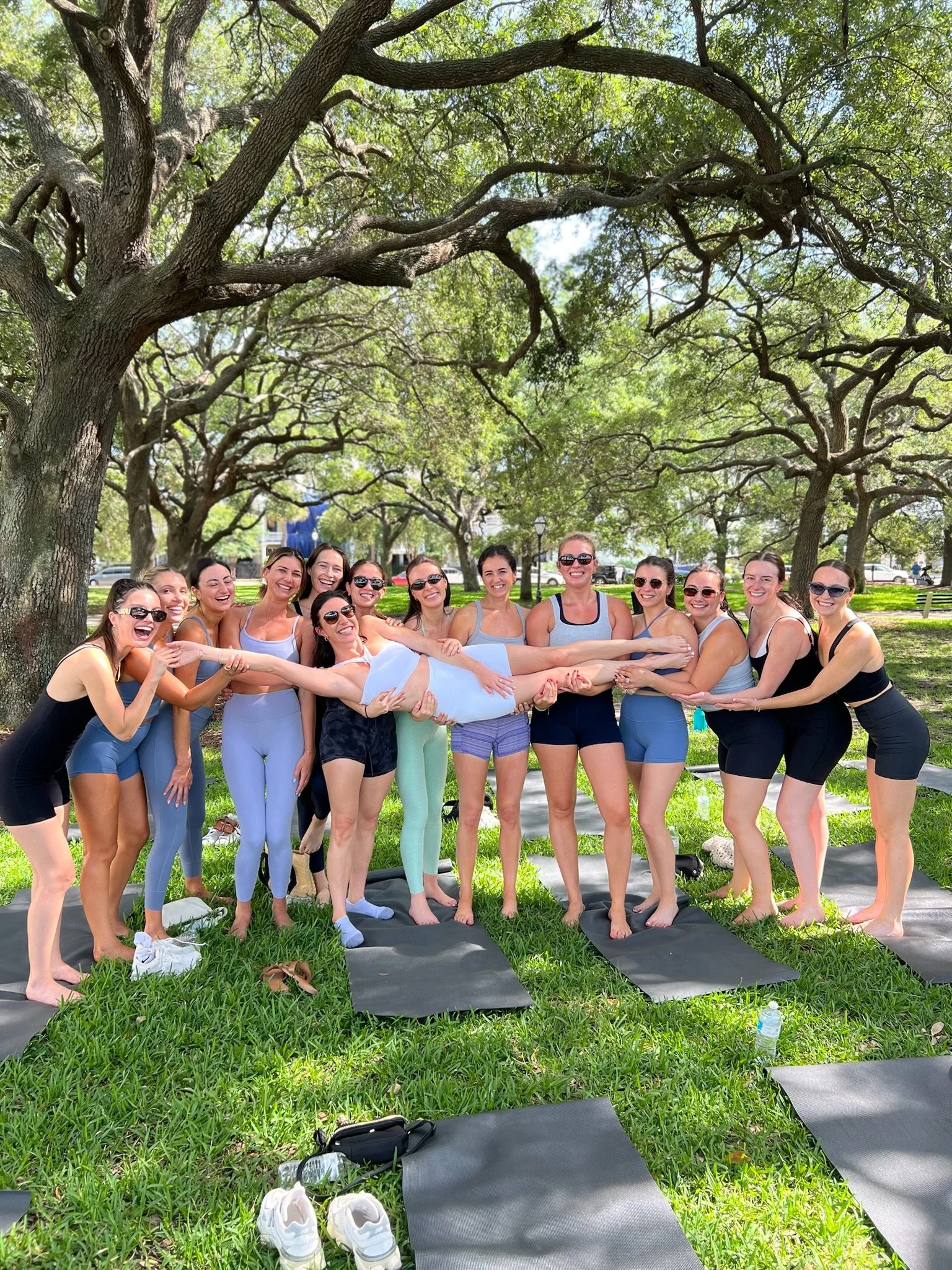 Bride tribe celebrating after a private yoga session at White Point Gardens in Charleston. 
