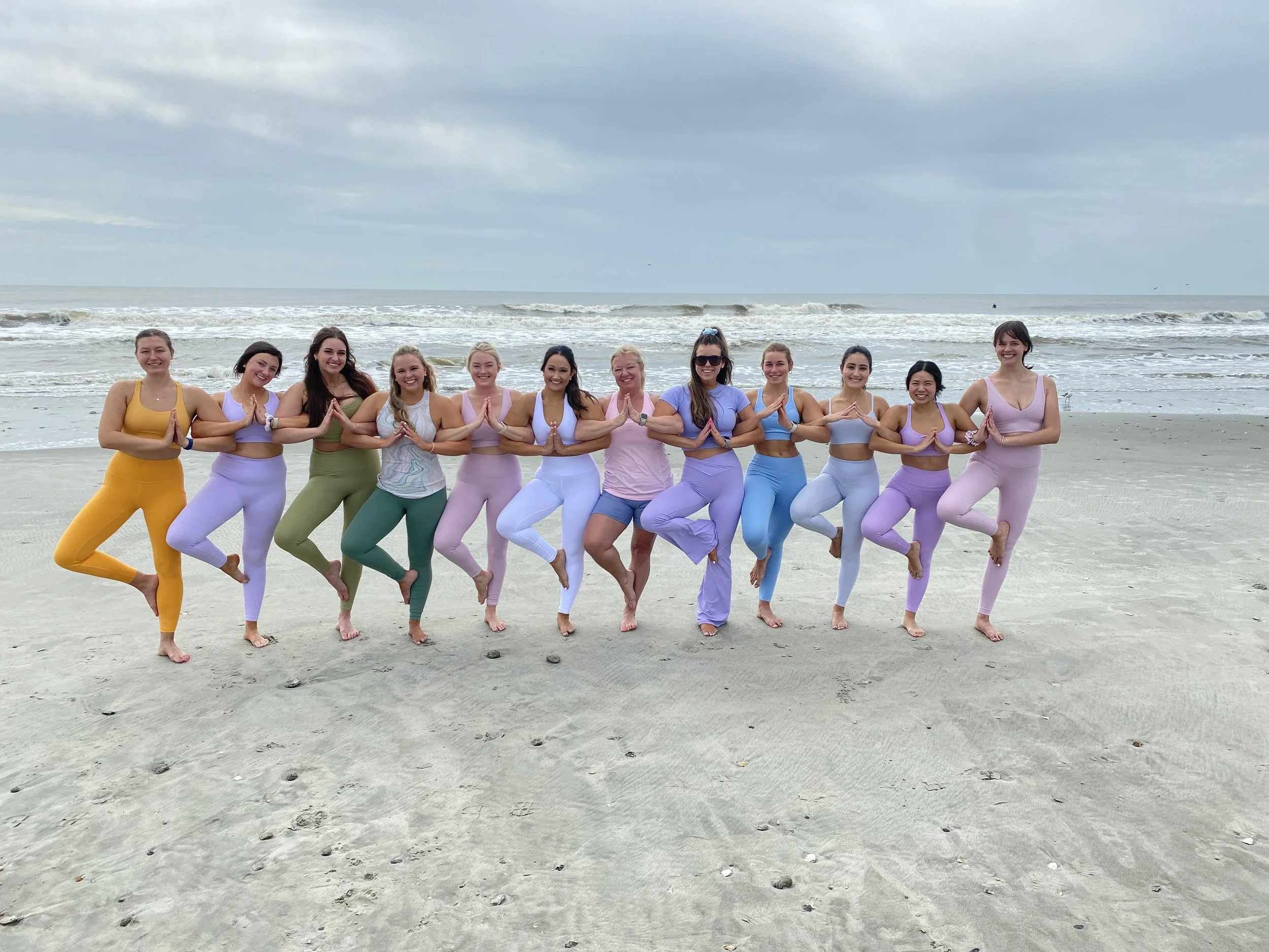 Group enjoying a private beach yoga session along the Charleston, South Carolina coast.