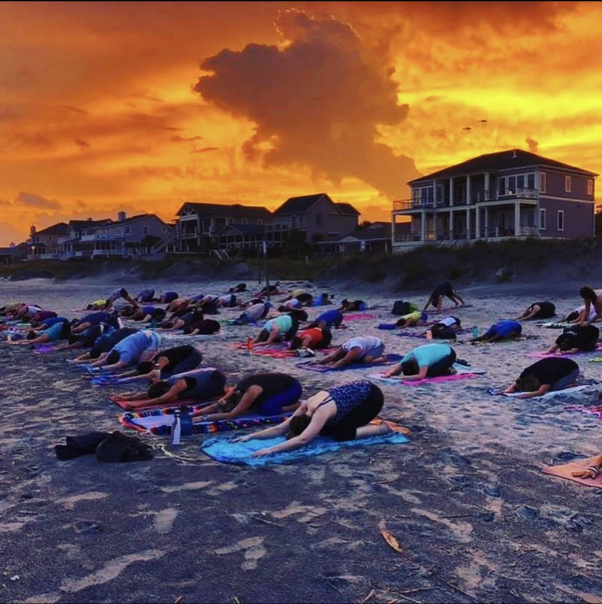 Sunset community beach yoga class on Folly Beach near Charleston, South Carolina with Serenity Tree Yoga