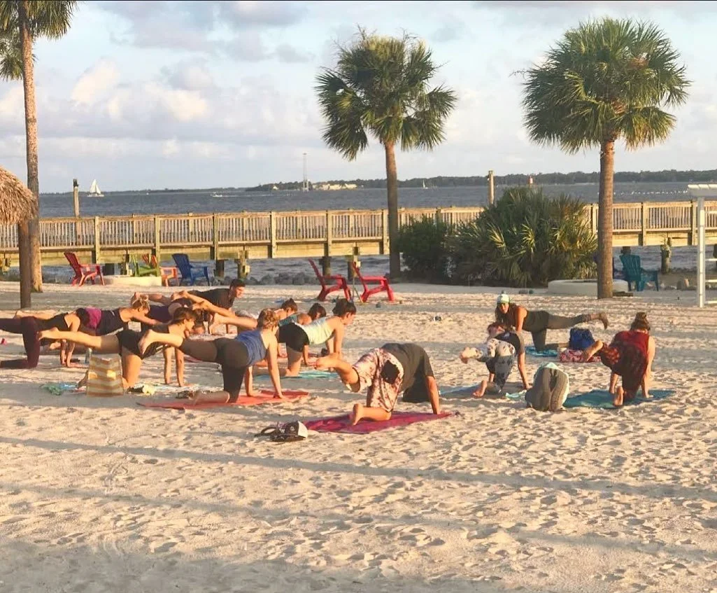 Sunday morning community beach yoga class at The Charleston Harbor Resort & Marina in Charleston, South Carolina.