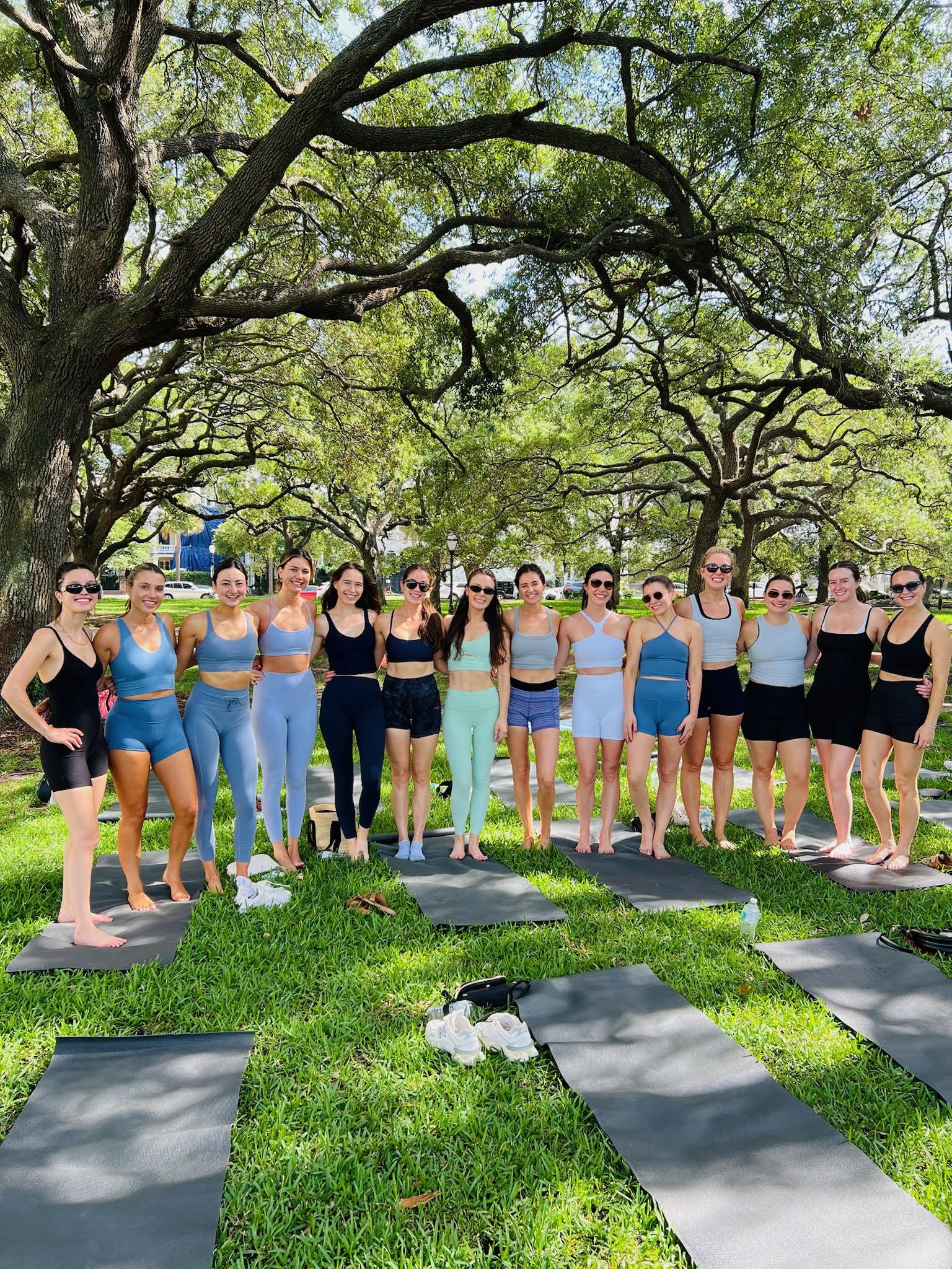 Group enjoying a private outdoor yoga session in one of Charleston, South Carolina's beautiful parks.