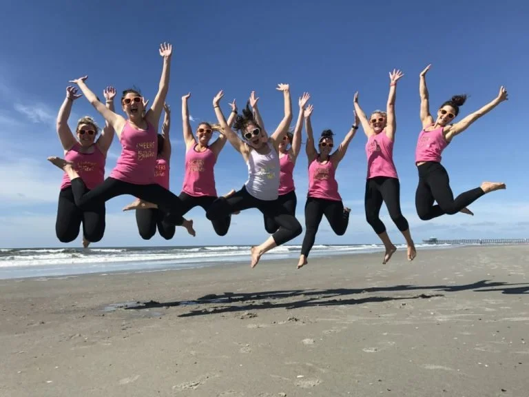 Celebrating the bride after a private beach yoga session on Folly Beach, near Charleston South Carolina. 