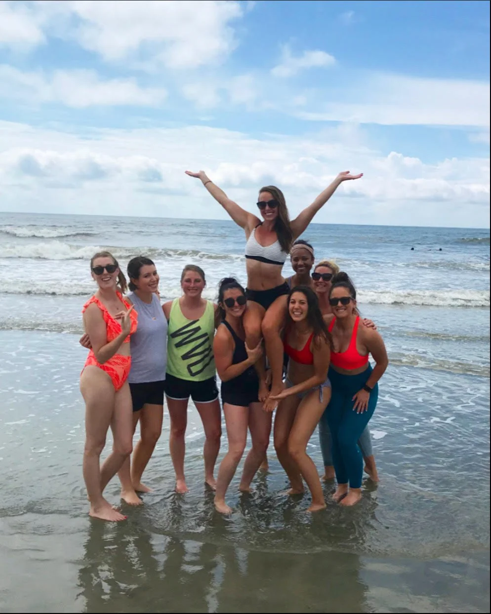 Friends celebrating a Charleston bachelorette party with private beach yoga and unforgettable memories. 