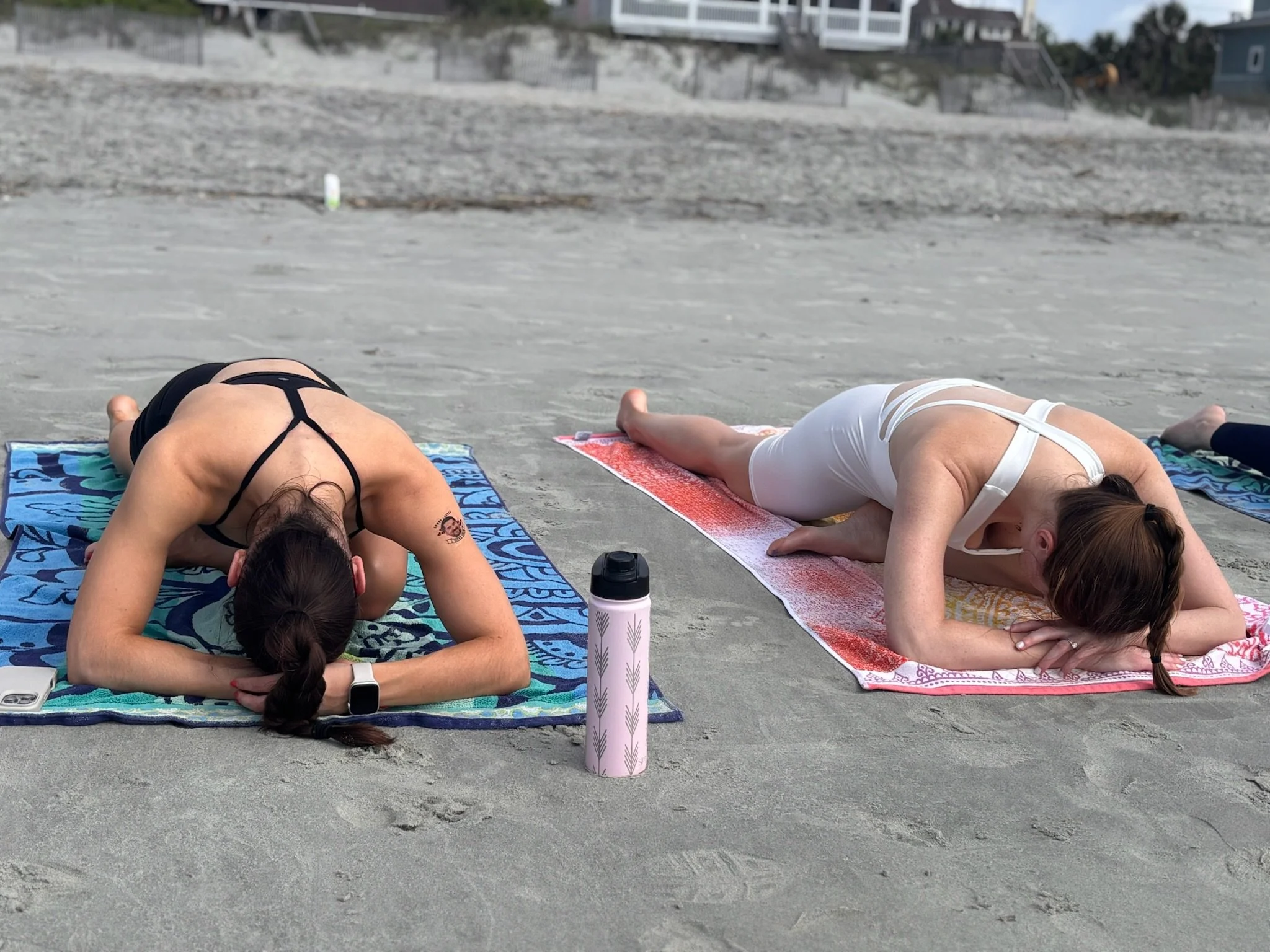 Bride tribe unwinding after a private beach yoga class on Folly Beach,