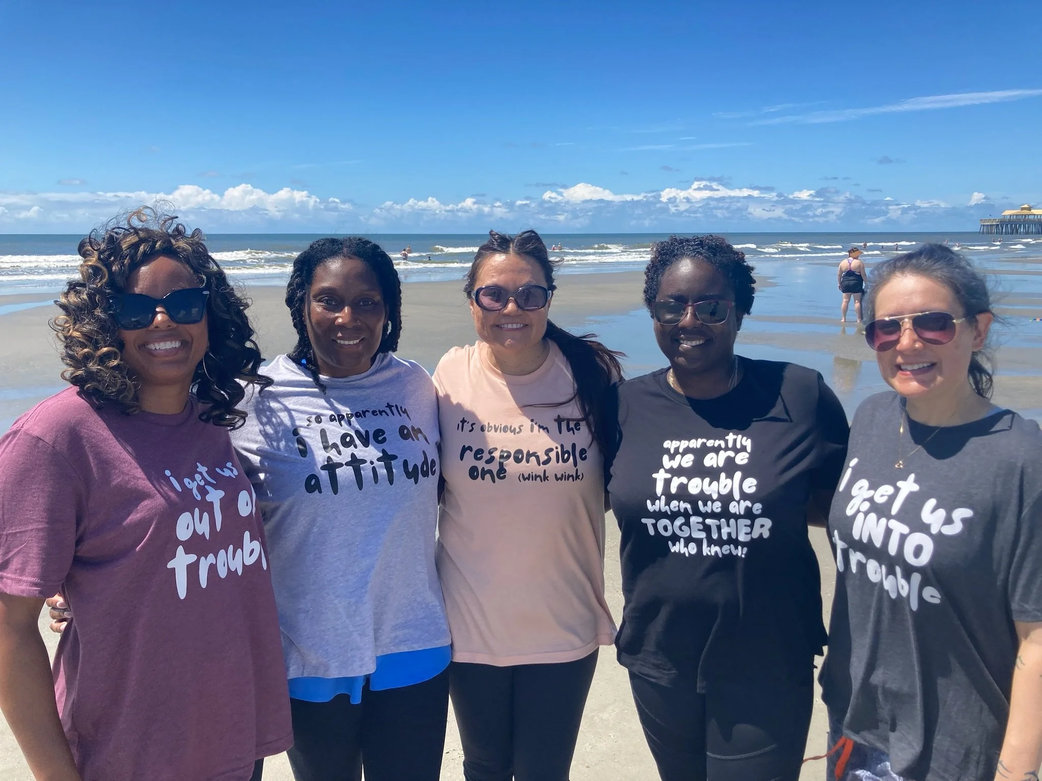 Friends enjoying a private beach yoga session during a girls' trip on Isle of Palms near Charleston, South Carolina.