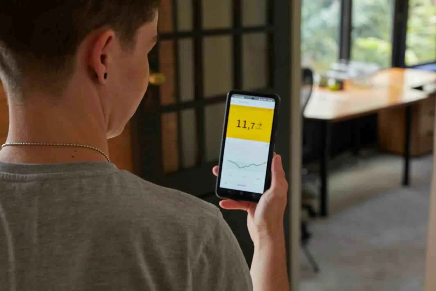 Boy looking at his glucose tracking results on phone