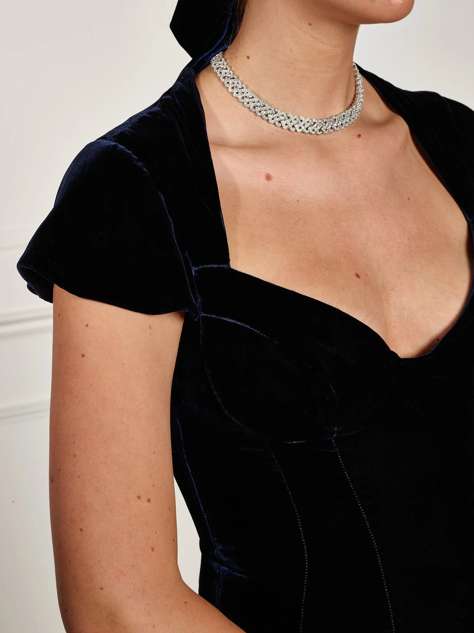 Close-up of corset bodice on Paget London navy velvet midi dress, showing precise seaming and luxury velvet texture