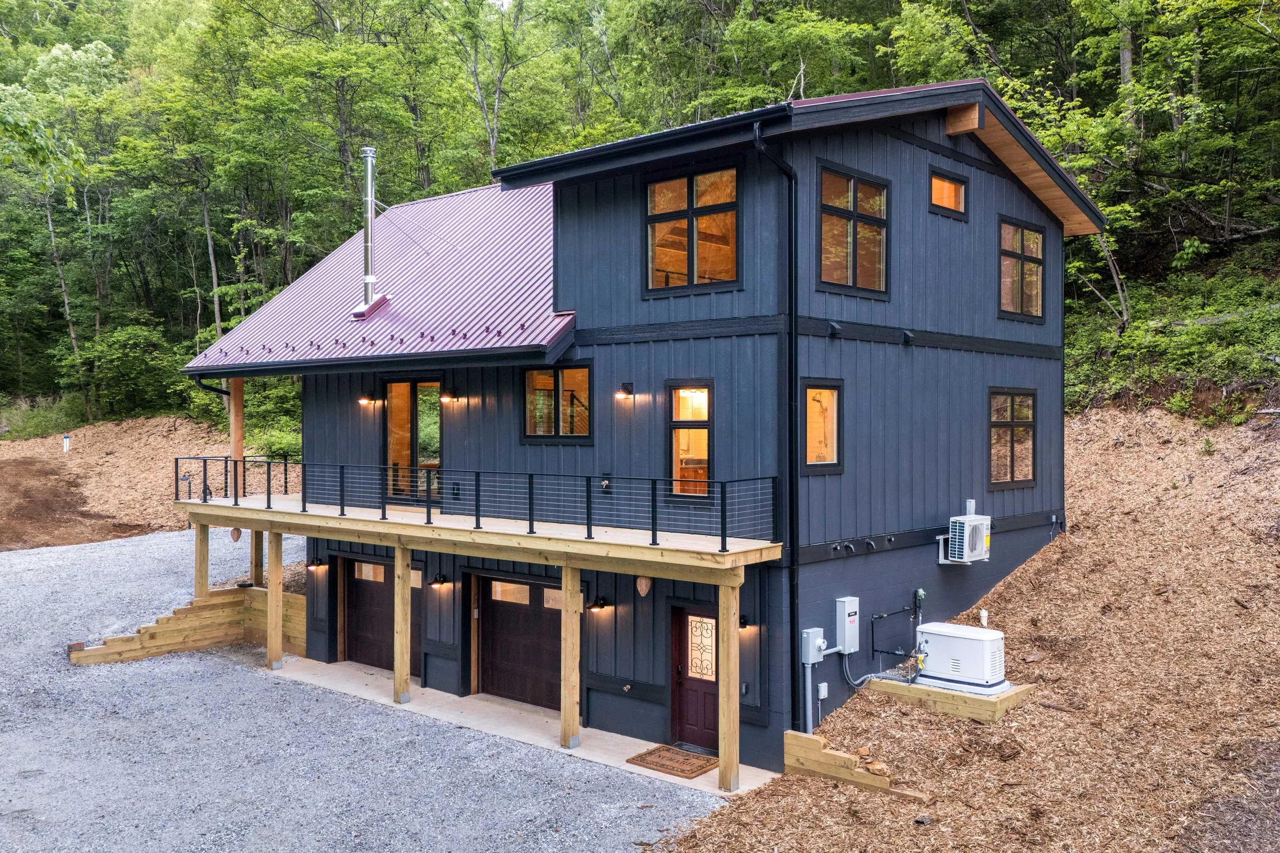 Large custom windows flood the interior with natural light while connecting the home to the surrounding Blue Ridge landscape.