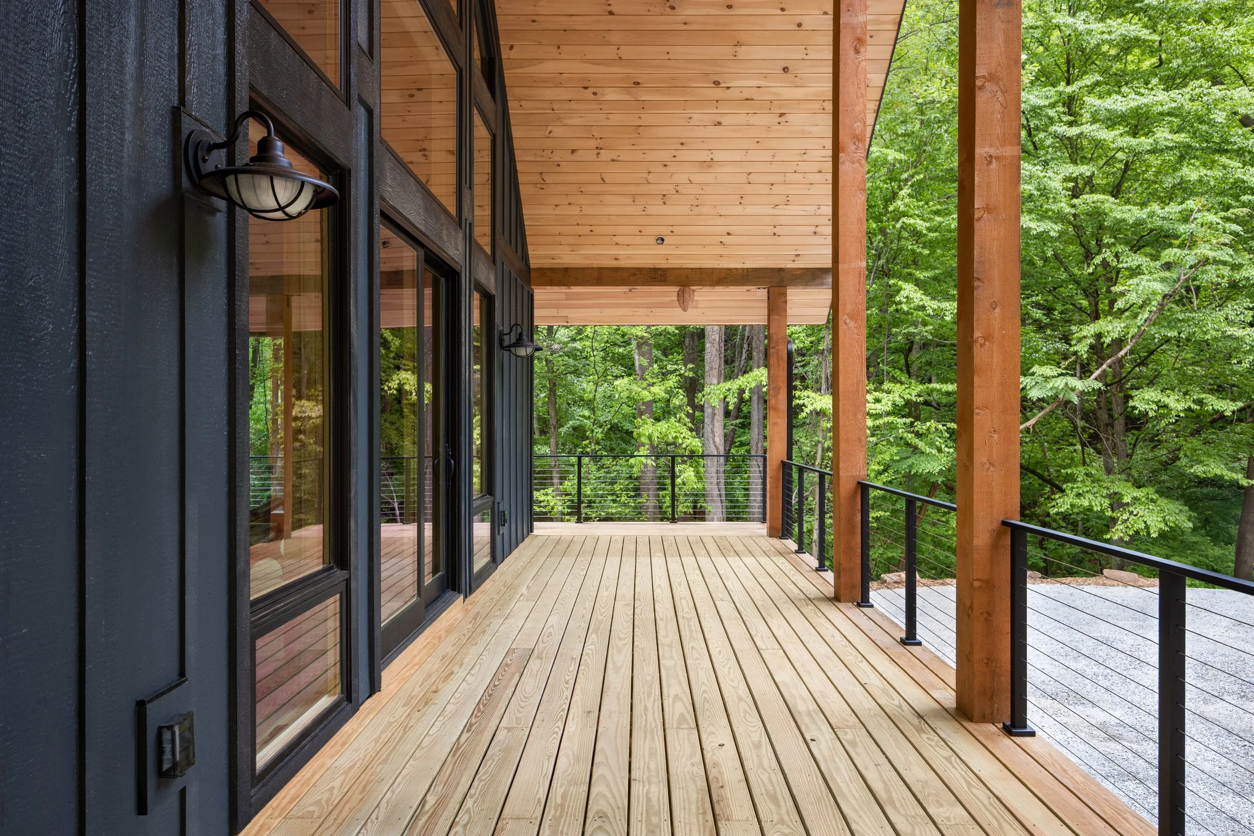 Located in Central Virginia, this luxury custom home is surrounded by forest, featuring contemporary mountain architecture and thoughtfully designed outdoor living spaces.
