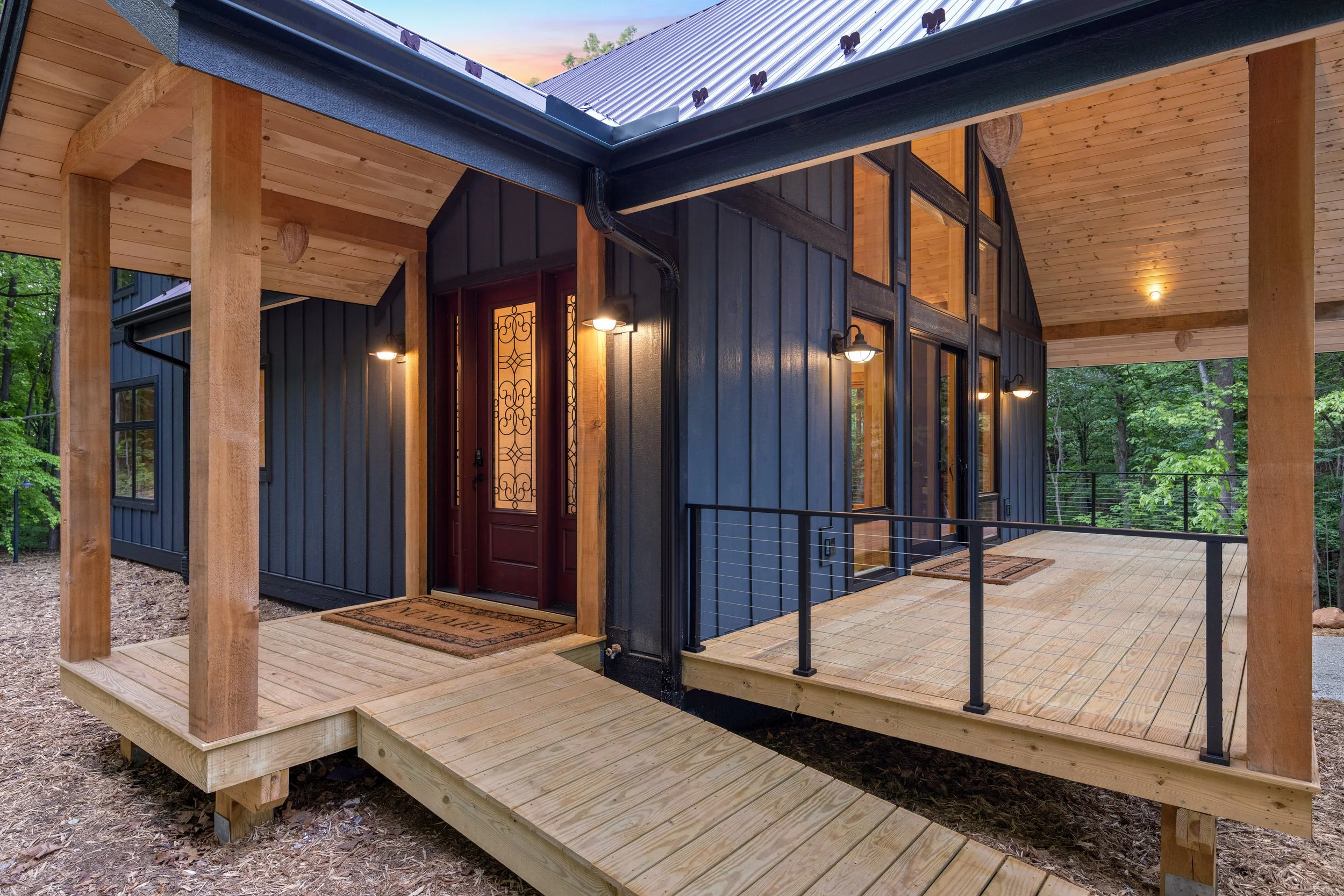 Covered front porch with timber posts and modern mountain styling designed to blend seamlessly with this Central Virginia wooded homesite