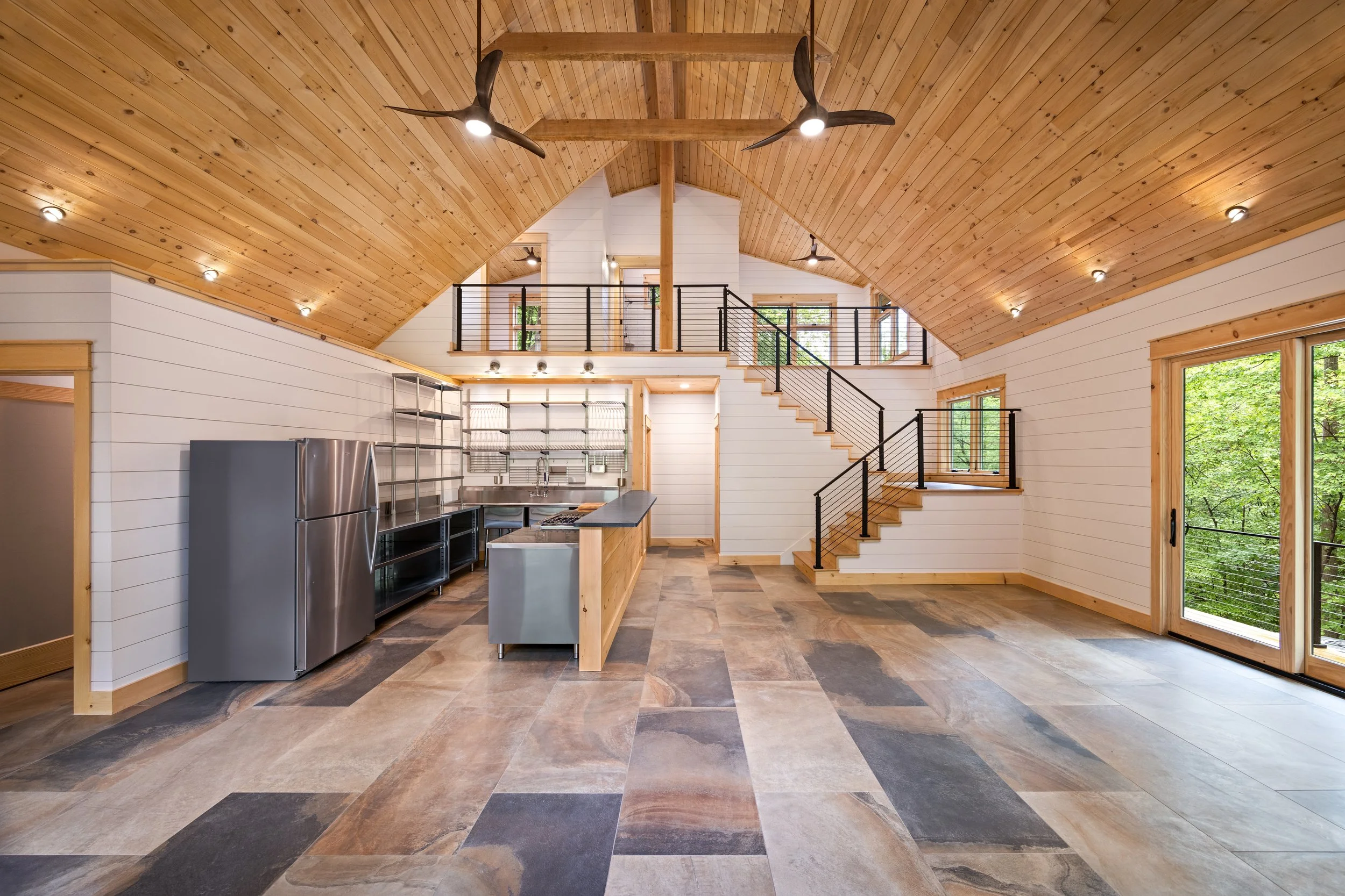 Open living spaces designed for entertaining with vaulted ceilings, custom finishes, and a seamless connection between the kitchen, dining, and great room. Surrounded by wooded views in Central Virginia.