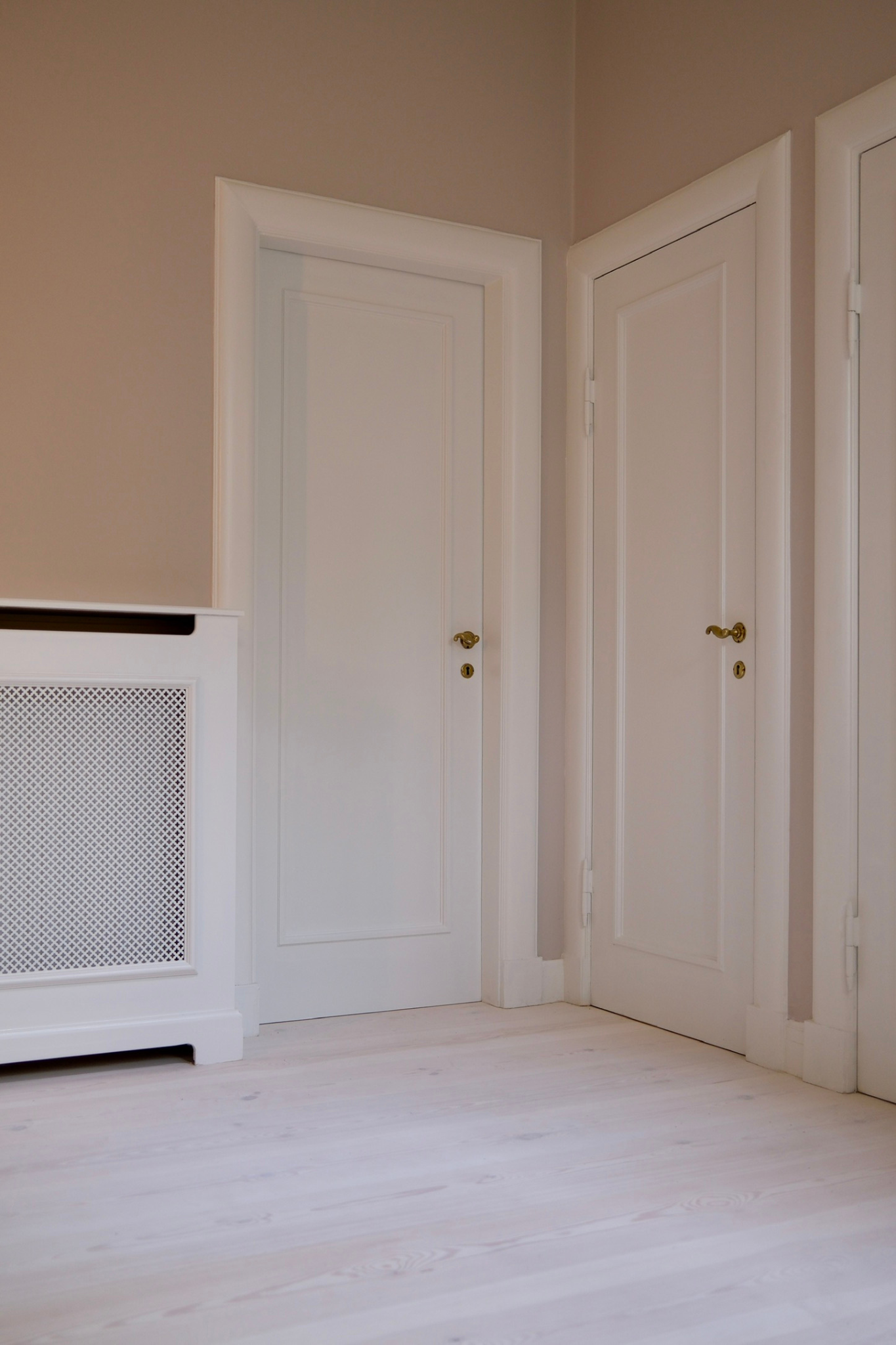 Specialbygget radiatorskjuler på mål med klassisk front, tilpasset boligens døre, paneler og øvrige træværk.
