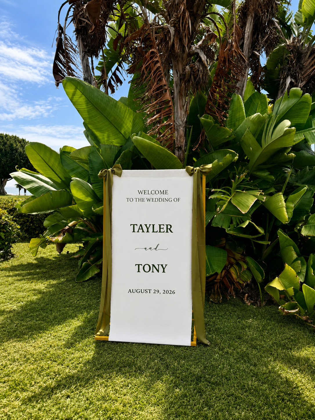 Personalized Wedding welcome sign made of fabric. Styled with olive green font and matching olive green satin ribbon on a gold stand