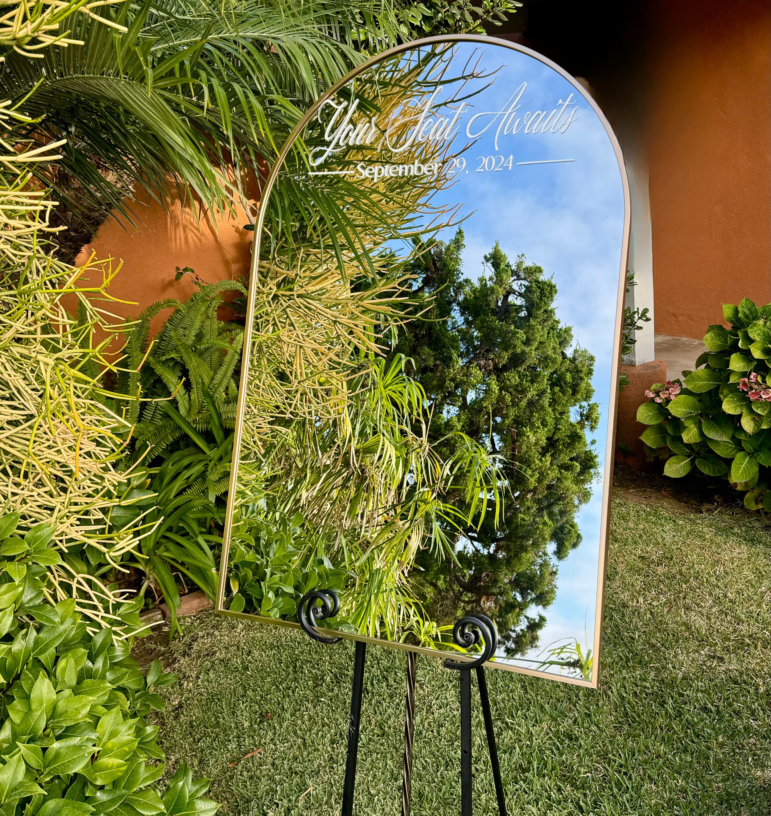 Your Seat Awaits Mirror arch seating chart sign for wedding reception display in San Diego.