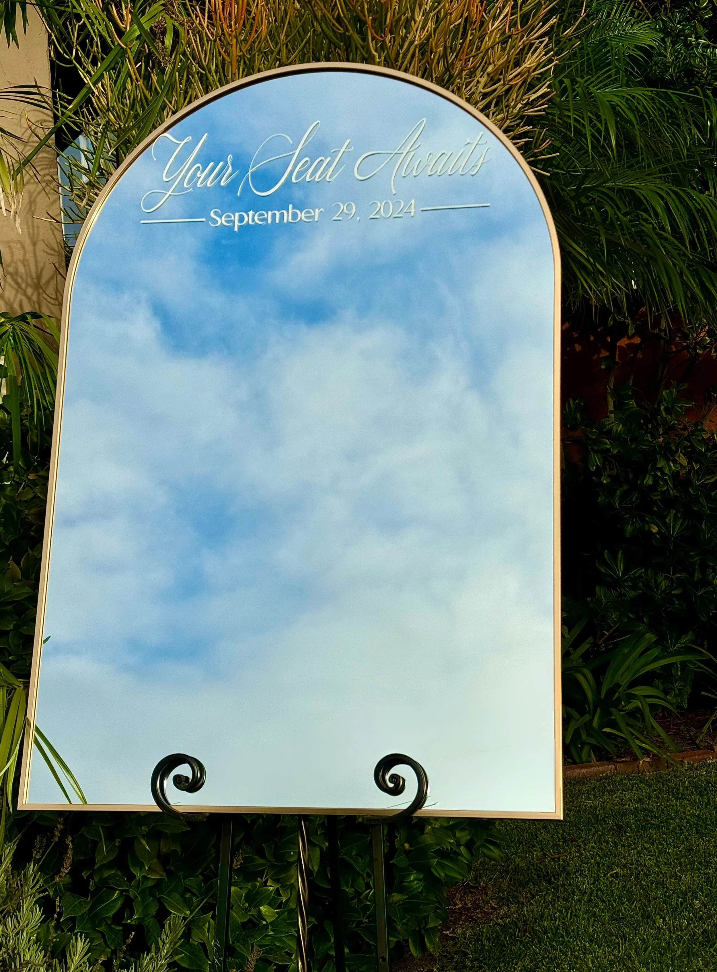 Your Seat Awaits Mirror arch seating chart sign for wedding reception display in San Diego.