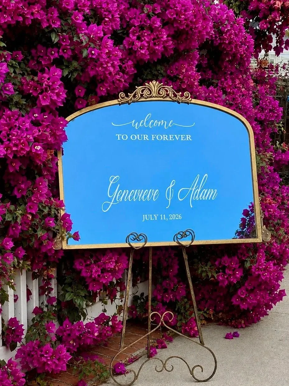 Gold Ornate wedding welcome mirror sign on a gold easel with the couples first names