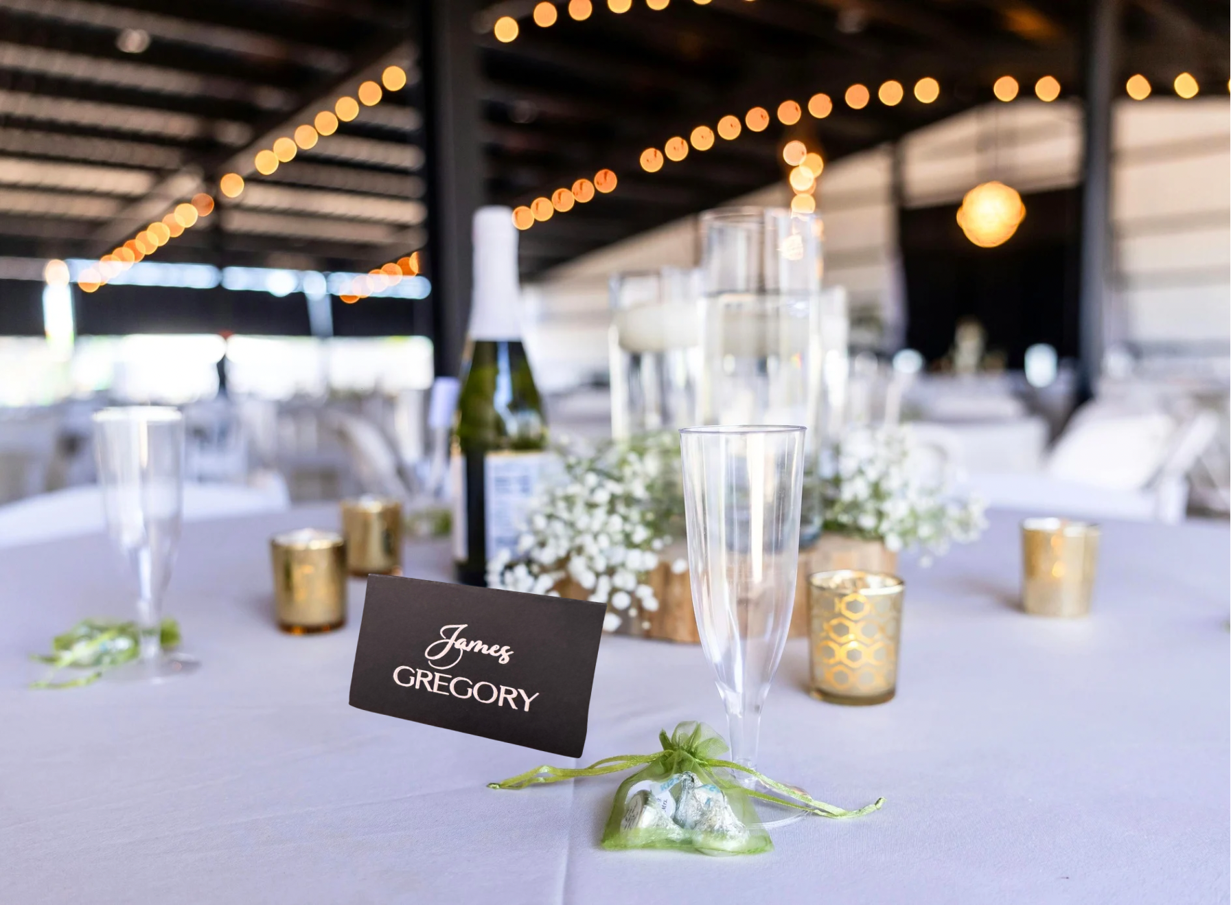 Black handwritten style wedding place cards with white script lettering on black cardstock