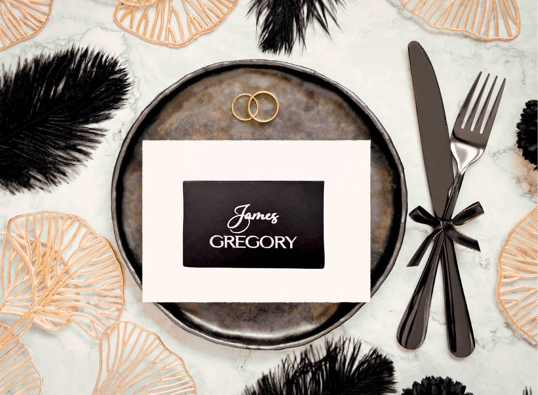 Black handwritten style wedding place cards with white script lettering on black cardstock