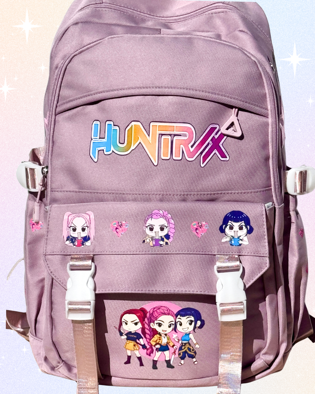 Huntrix girls dusky pink K-Pop Demon Hunters school backpack with laptop compartment, anti-theft back pocket, and multiple storage pockets.