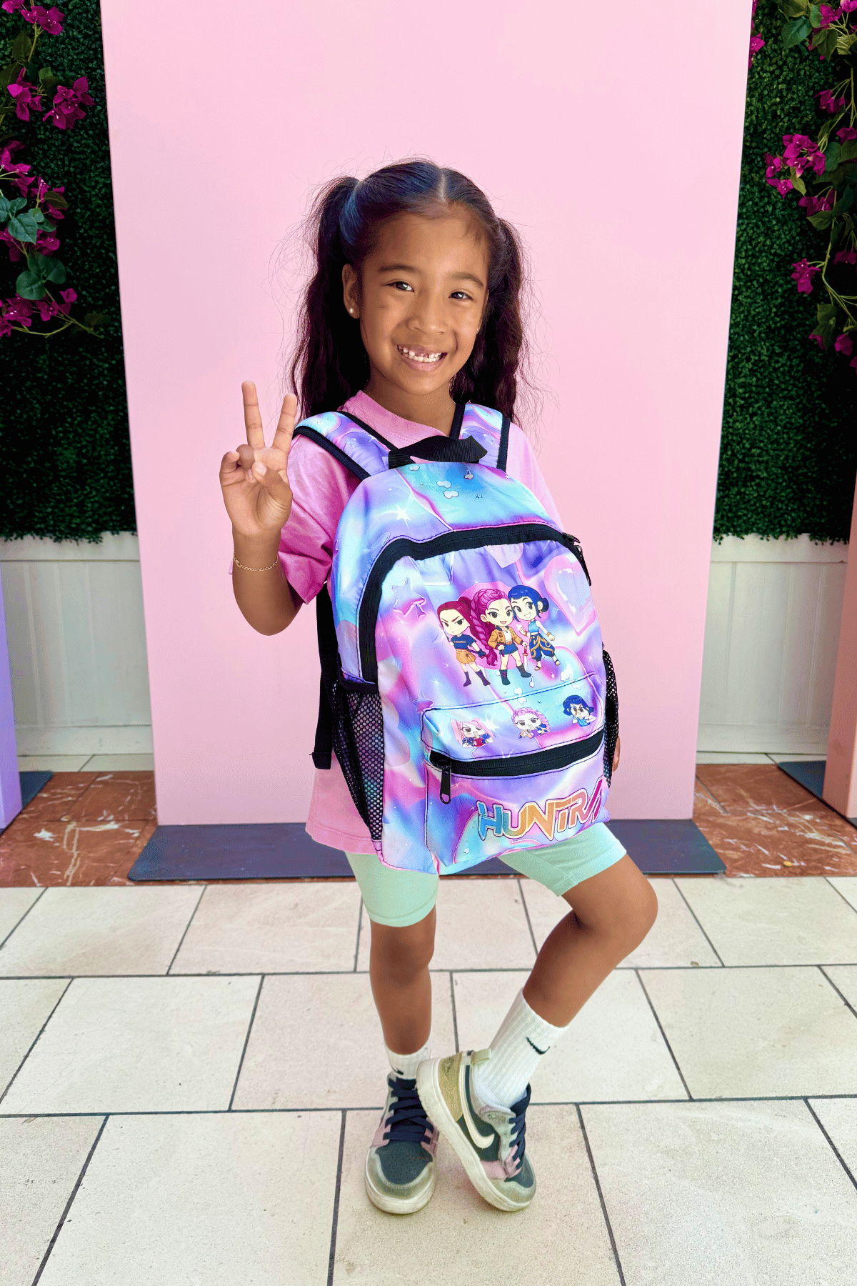 K-Pop Demon Hunters Huntrix girls mini backpack in purple, compact kids school bag with adjustable straps and front zip pocket.