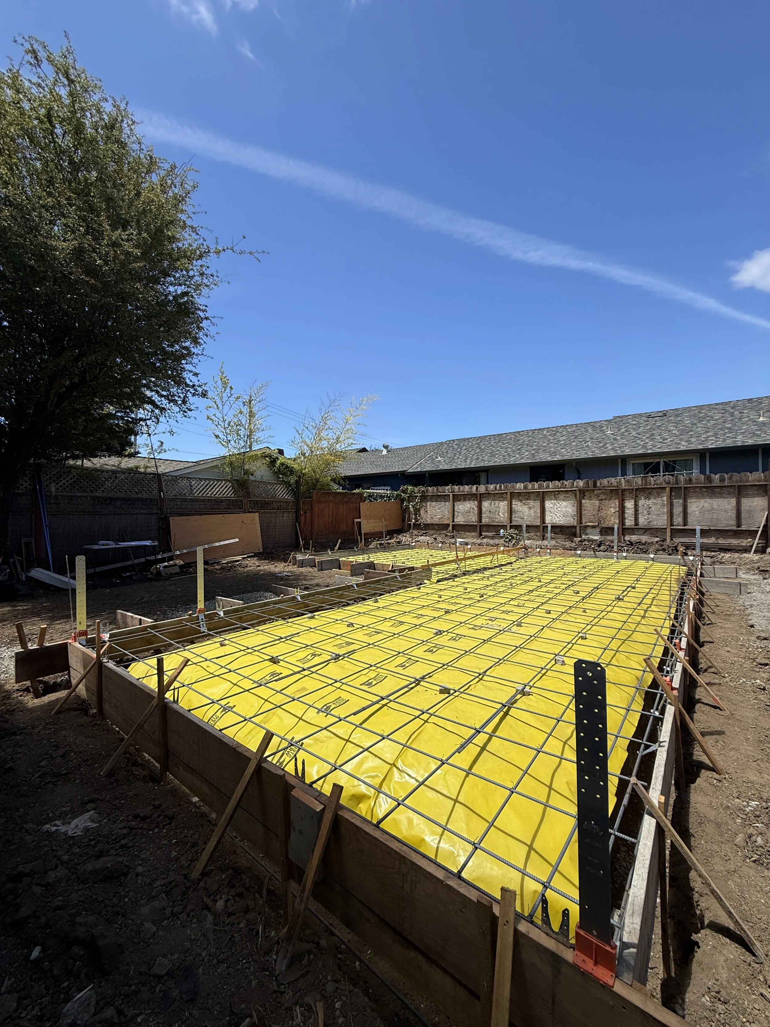 Preparation for concrete slab with yellow vapor barrier and rebar grid