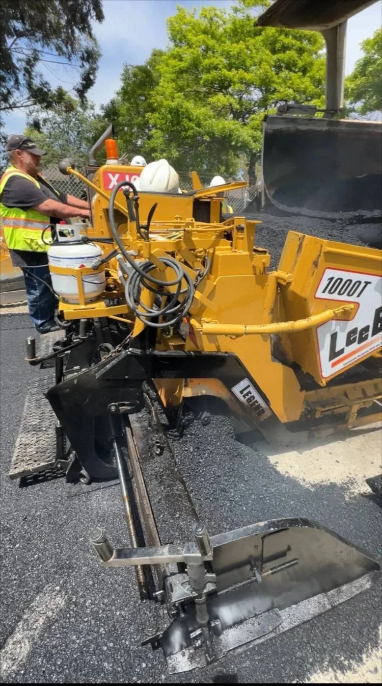 Asphalt paving machine laying a new driveway on California's Central Coast
