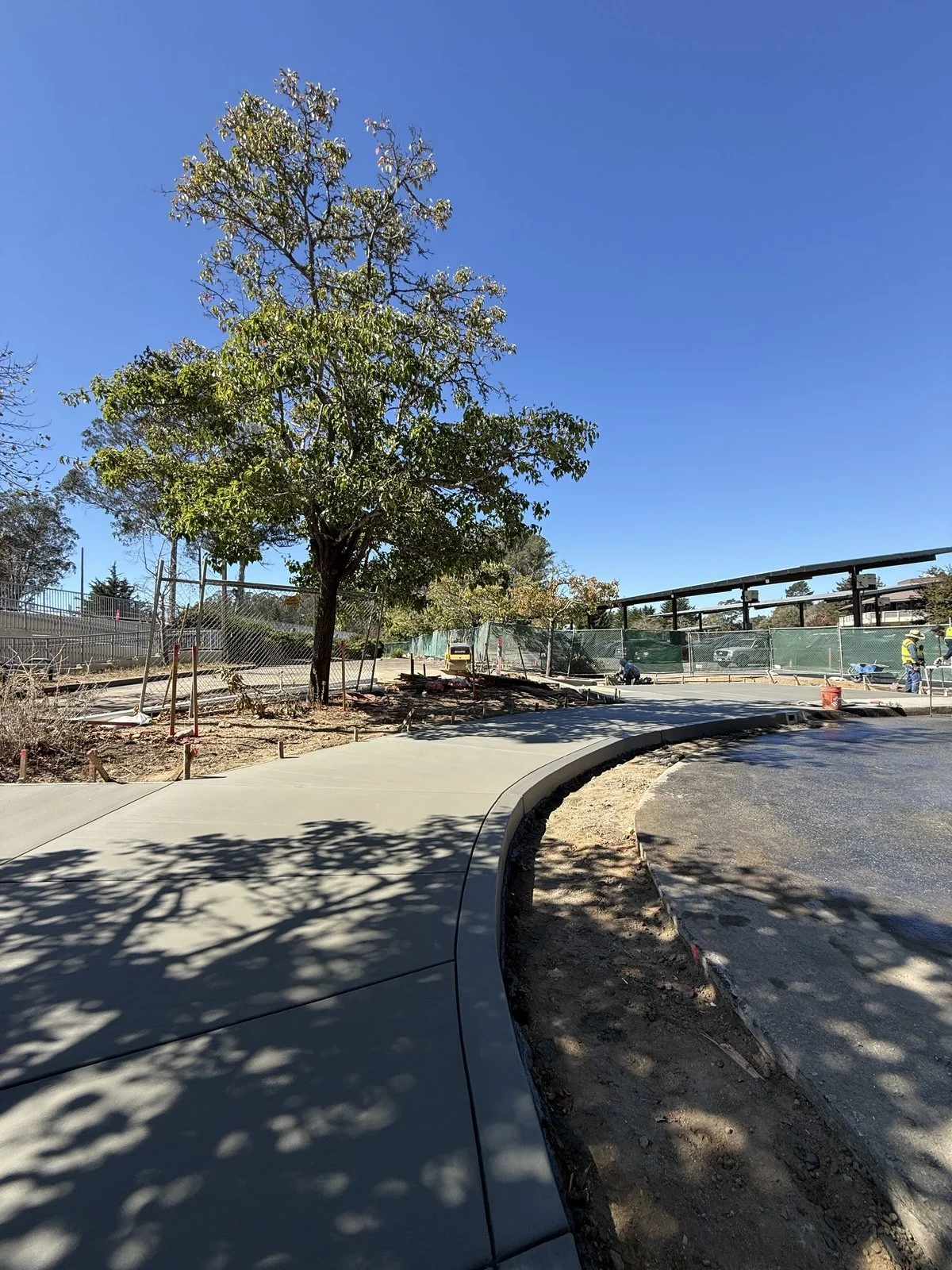 Curved concrete walkway and curb poured by our crew over 6 inches of new base rock