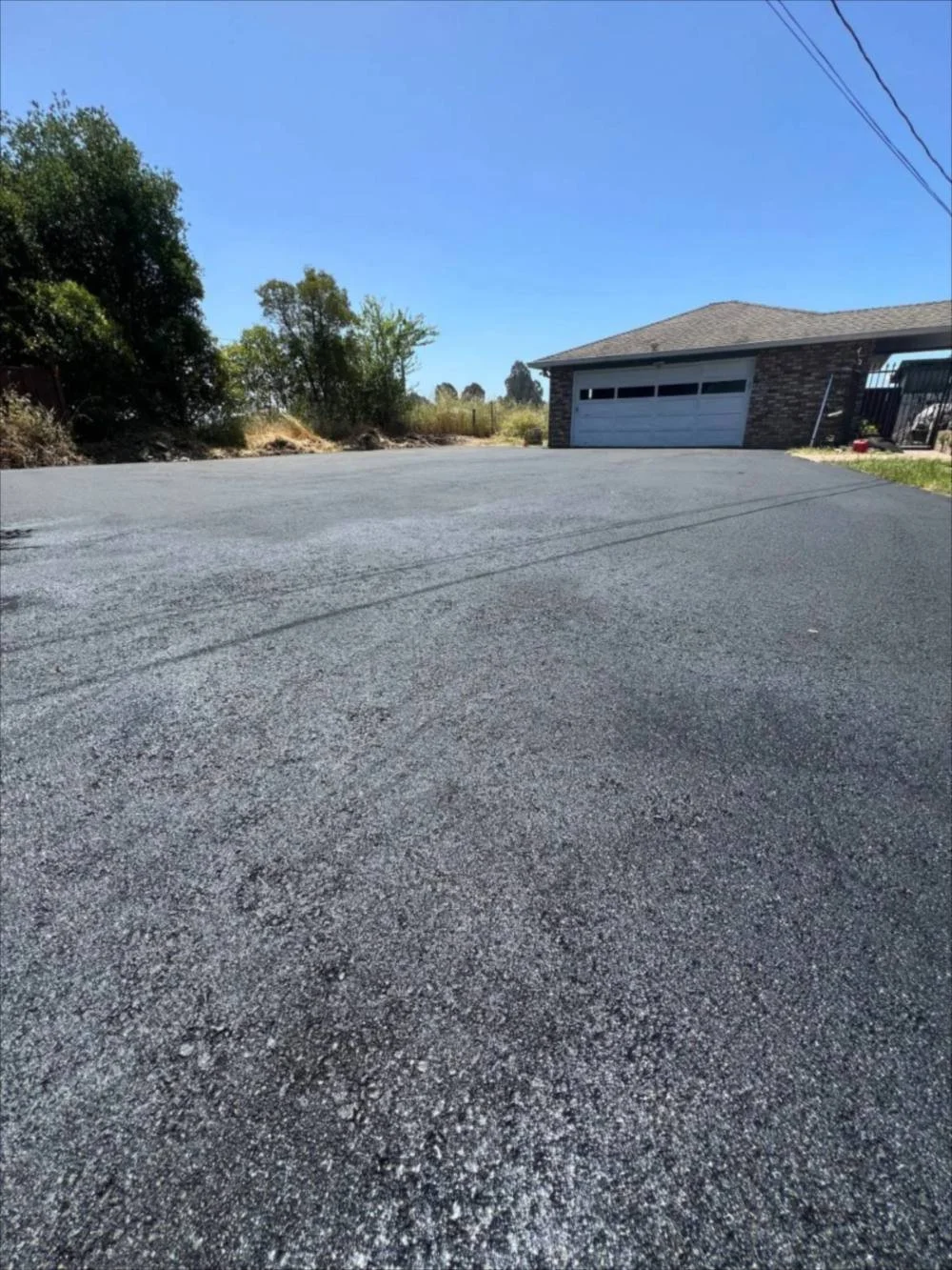 New asphalt driveway paving at a home in Santa Cruz County by Freedom Earthworks