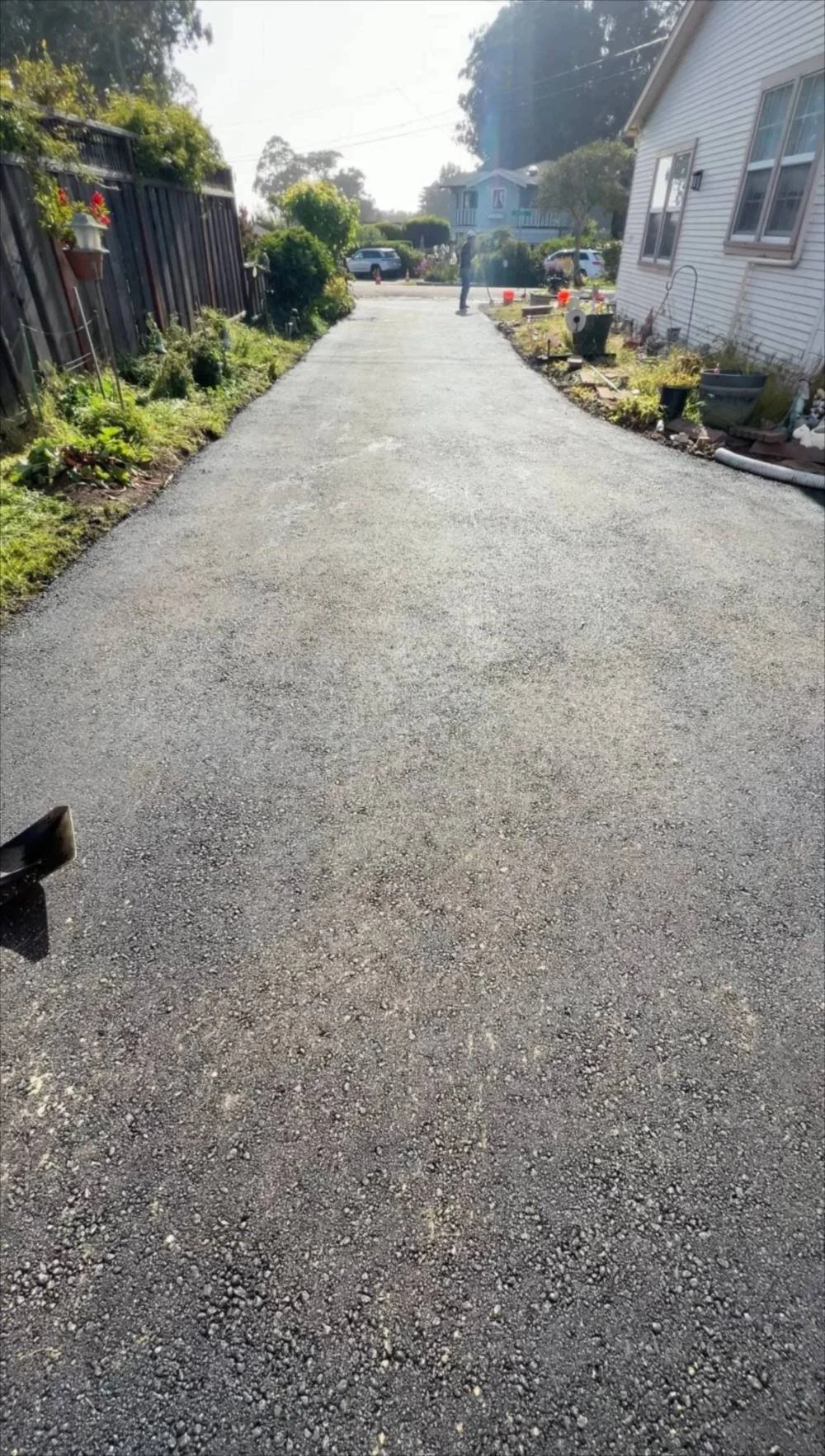 Long asphalt driveway beside a home in Santa Cruz County