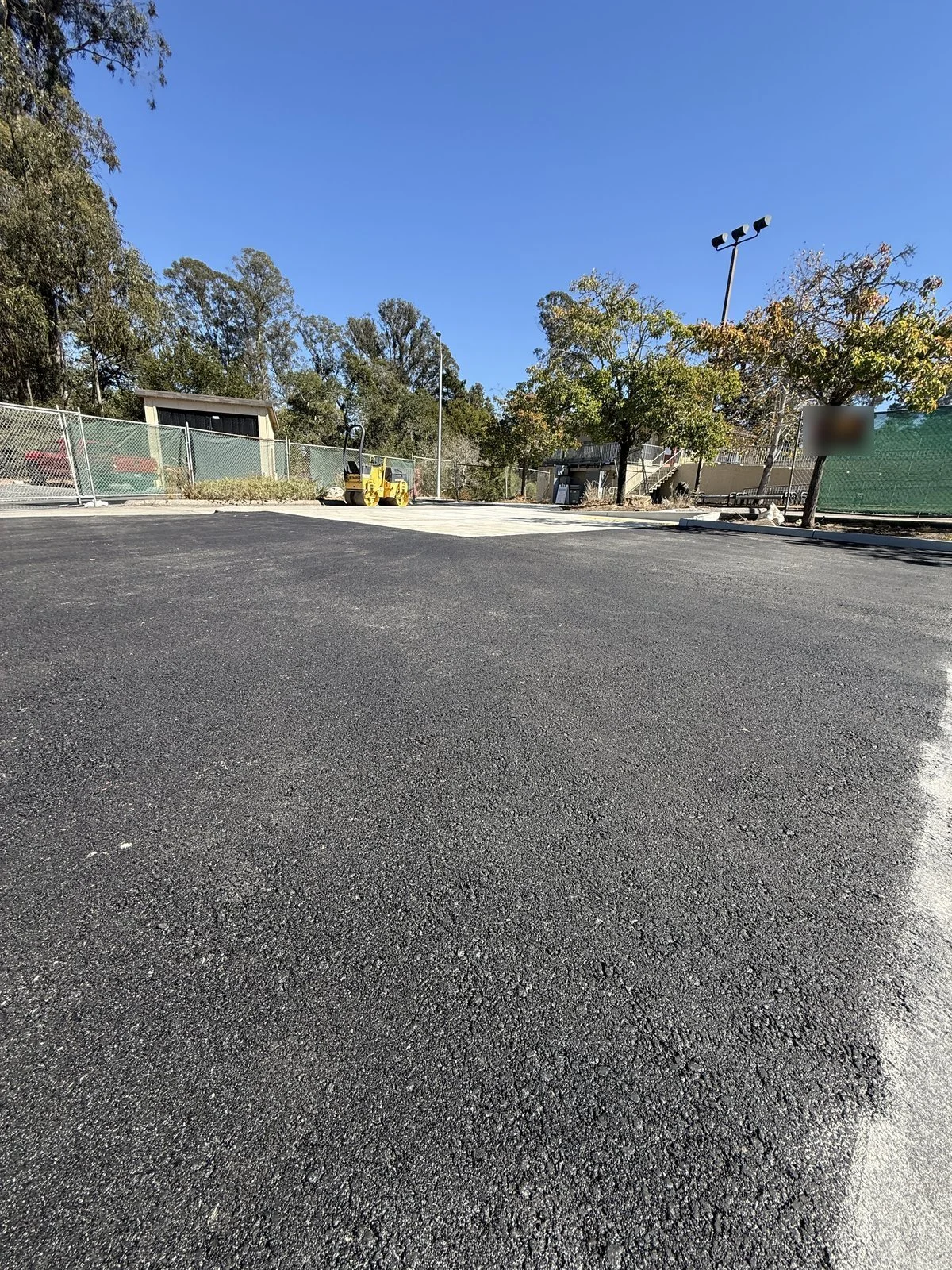 New asphalt paved up to the new concrete to tie it into the existing pavement