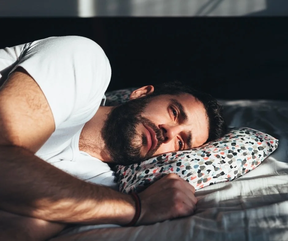 Many with sad look laying down on a pillow