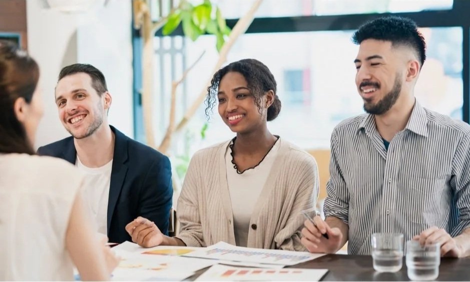 Two men and two women sitting around a conference table