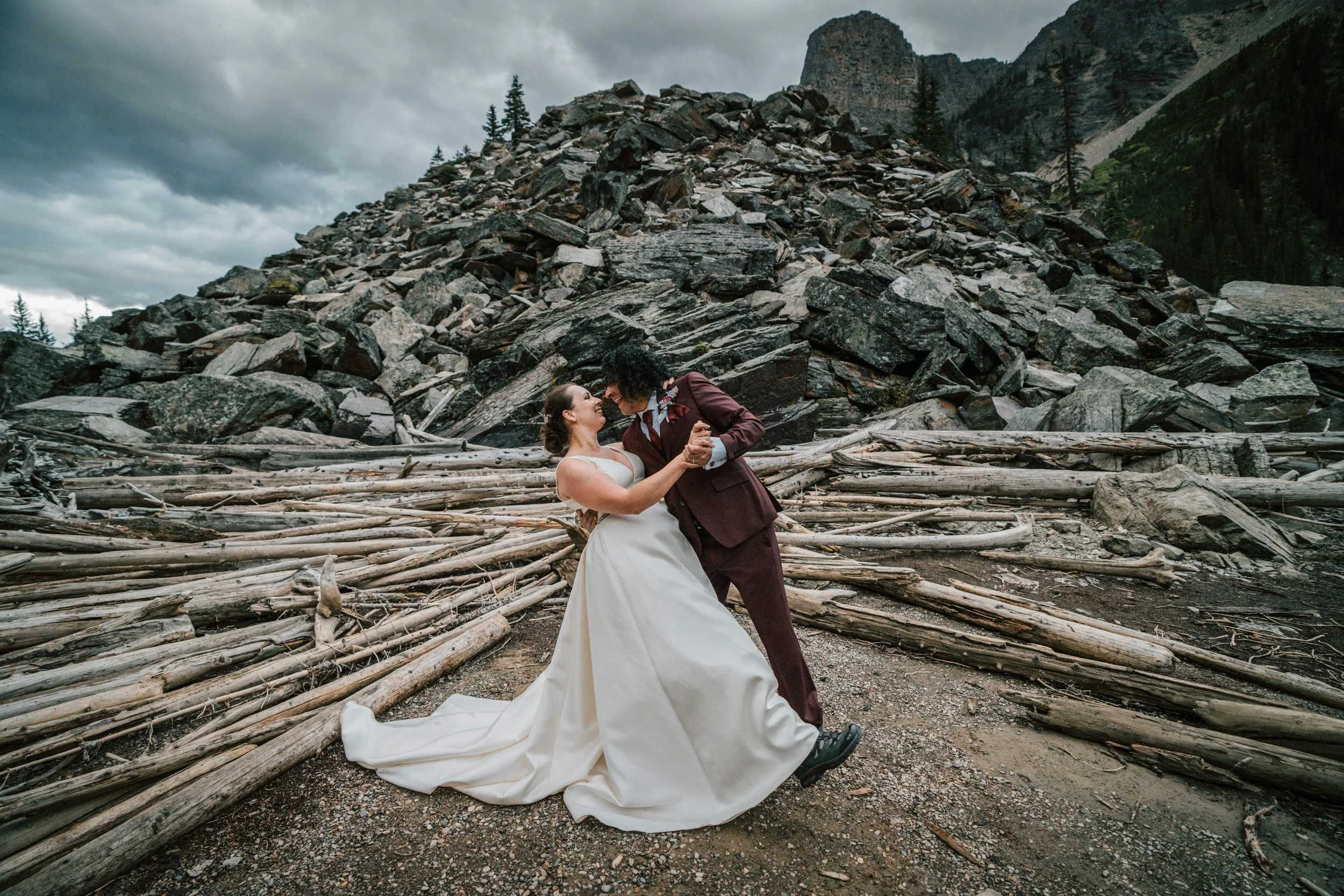 oscar-michaela-moraine-lake-wedding-dance.jpg
Alt text: Oscar and Michaela dancing and laughing in front of the driftwood log pile at Moraine Lake Banff National Park