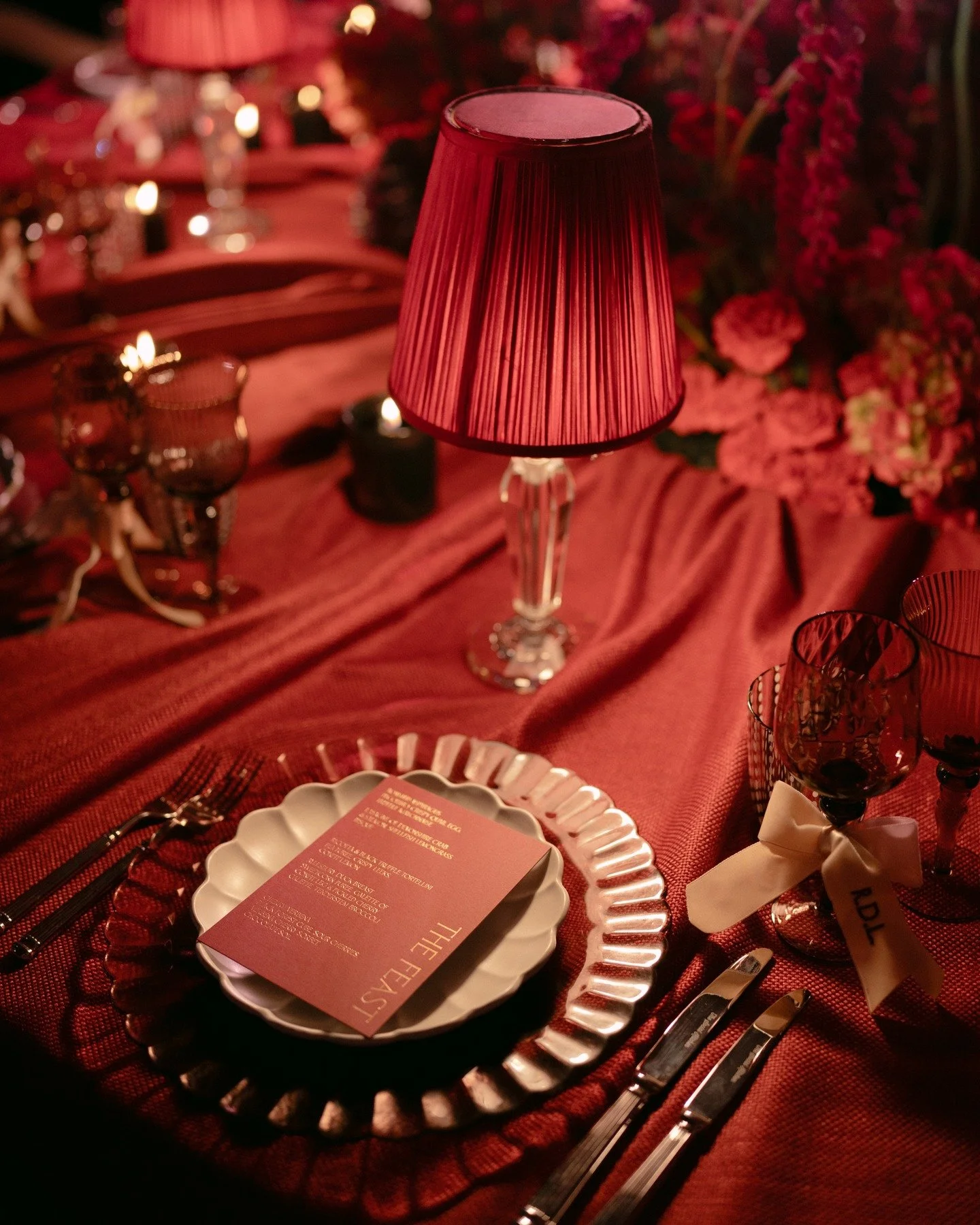 A moody, modern tablescape layered in velvet, candlelight, and deep crimson hues: the perfect home for these rich red and gold menus. There&rsquo;s something utterly captivating about pairing minimal, clean type with such indulgent texture.

When I&r