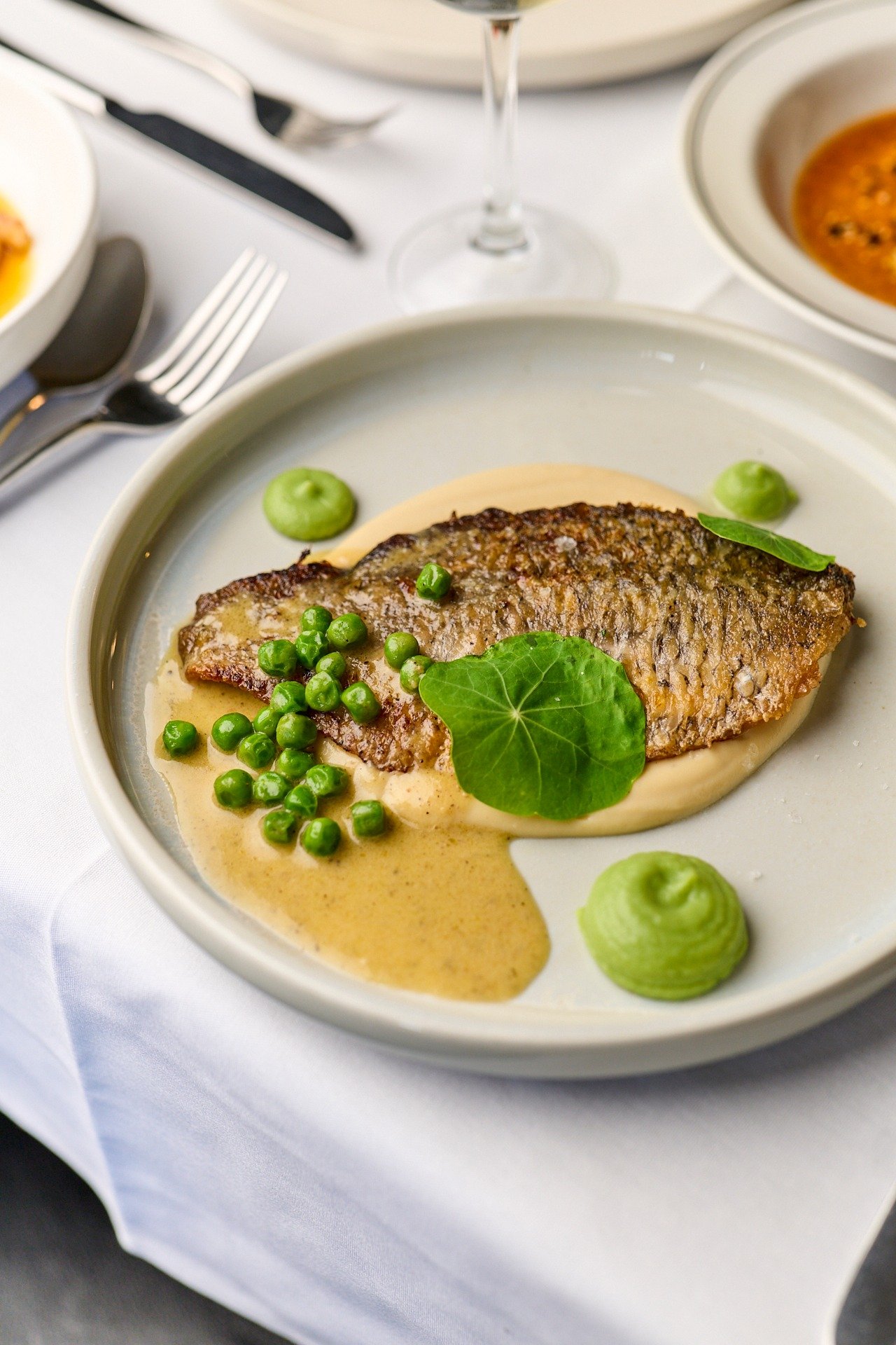 FIGHTING OVER FISH 🐟

Featuring our signature Baby barramundi pan seared with beurre blanc, peas &amp; pea gel, cauliflower pur&eacute;e.