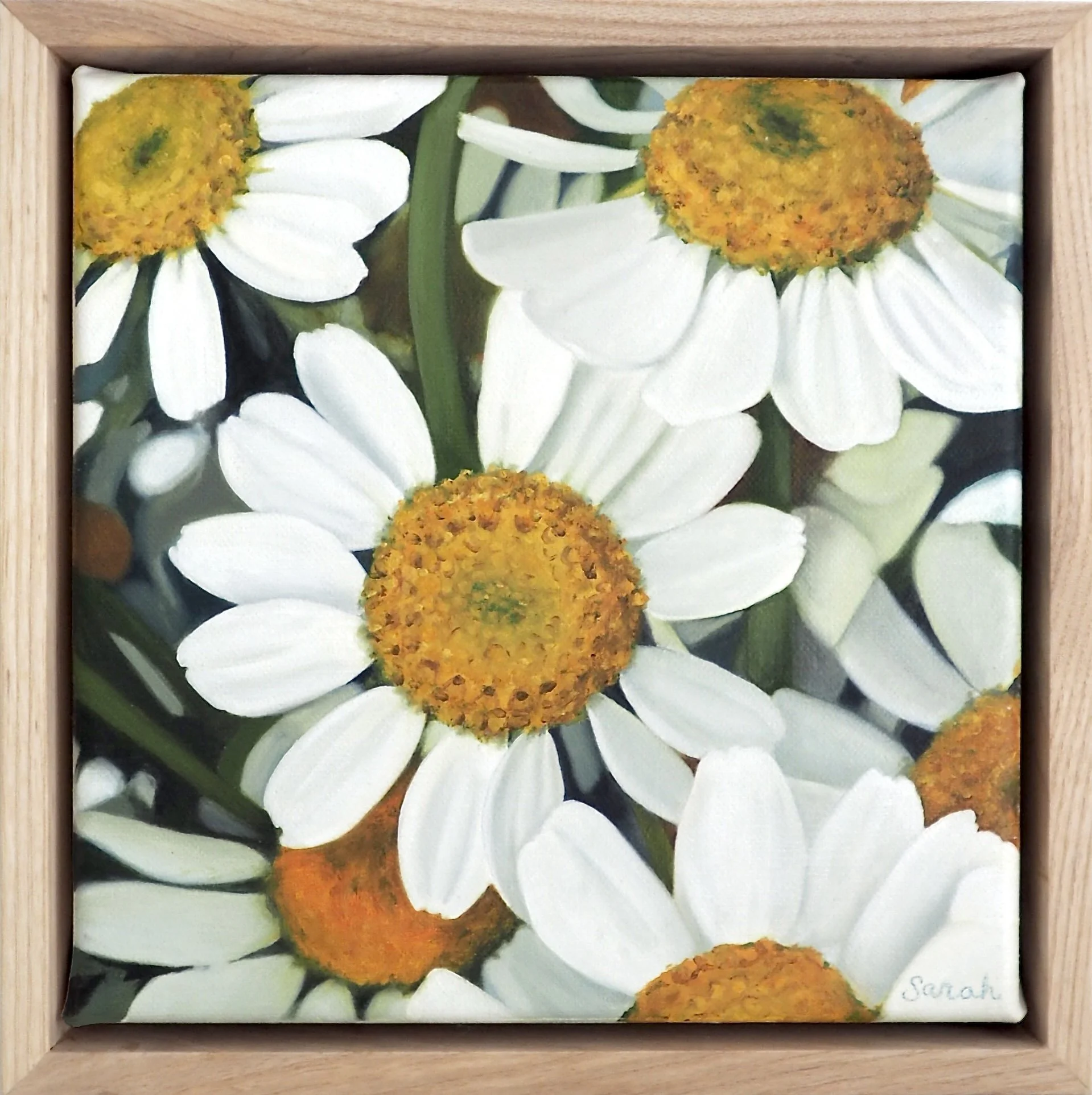 A painting of white daisies with yellow centers in a wooden frame.